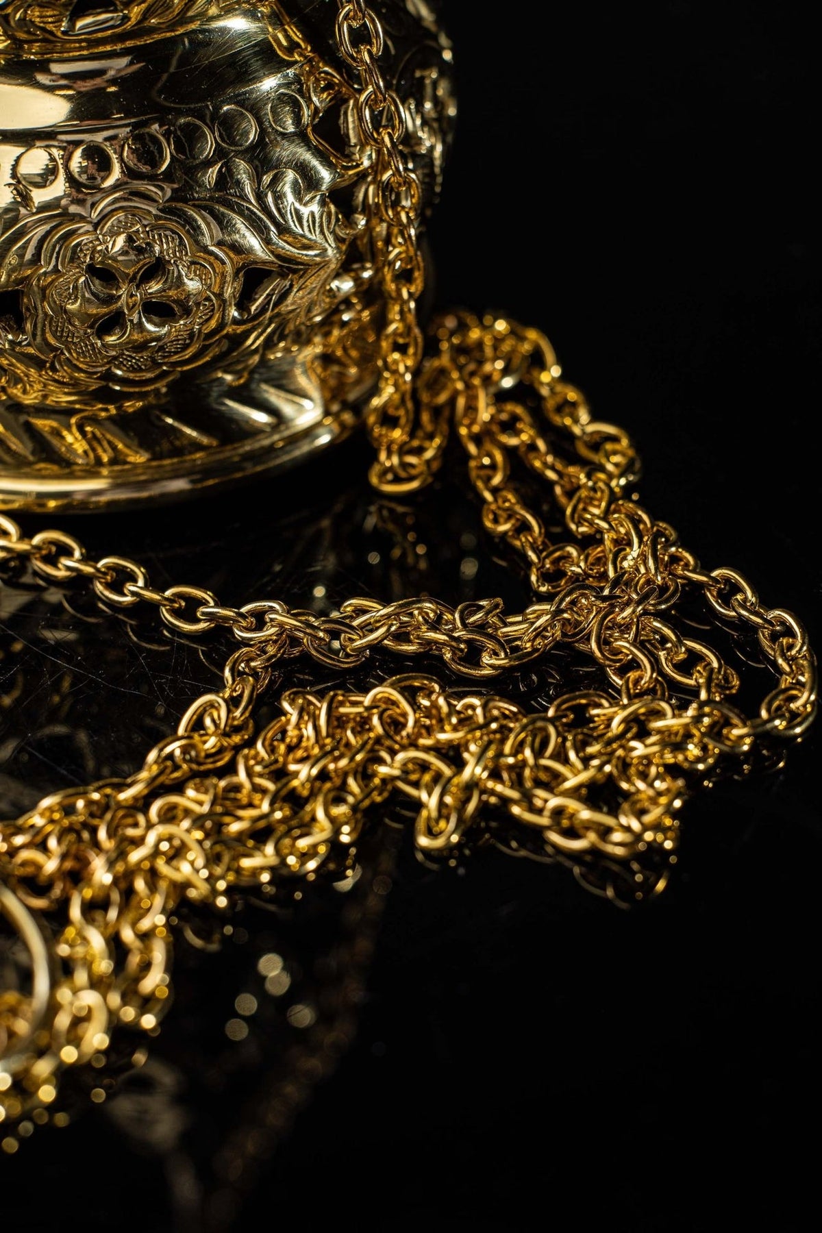 Brass thurible bell close-up with hanging ring and chains