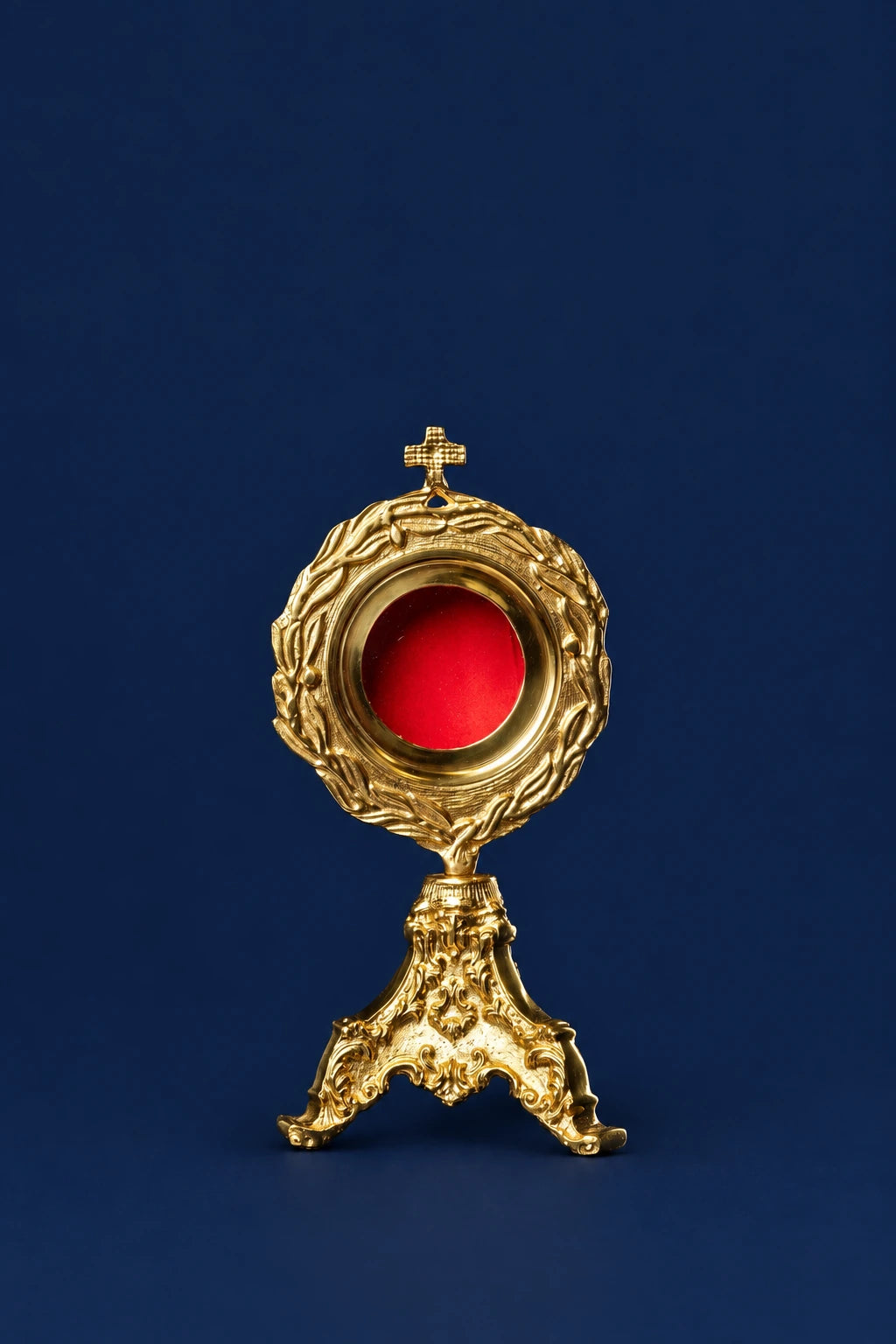 Brass Reliquary with Wreath Motif and Cross, full front view with red center and ornate stand