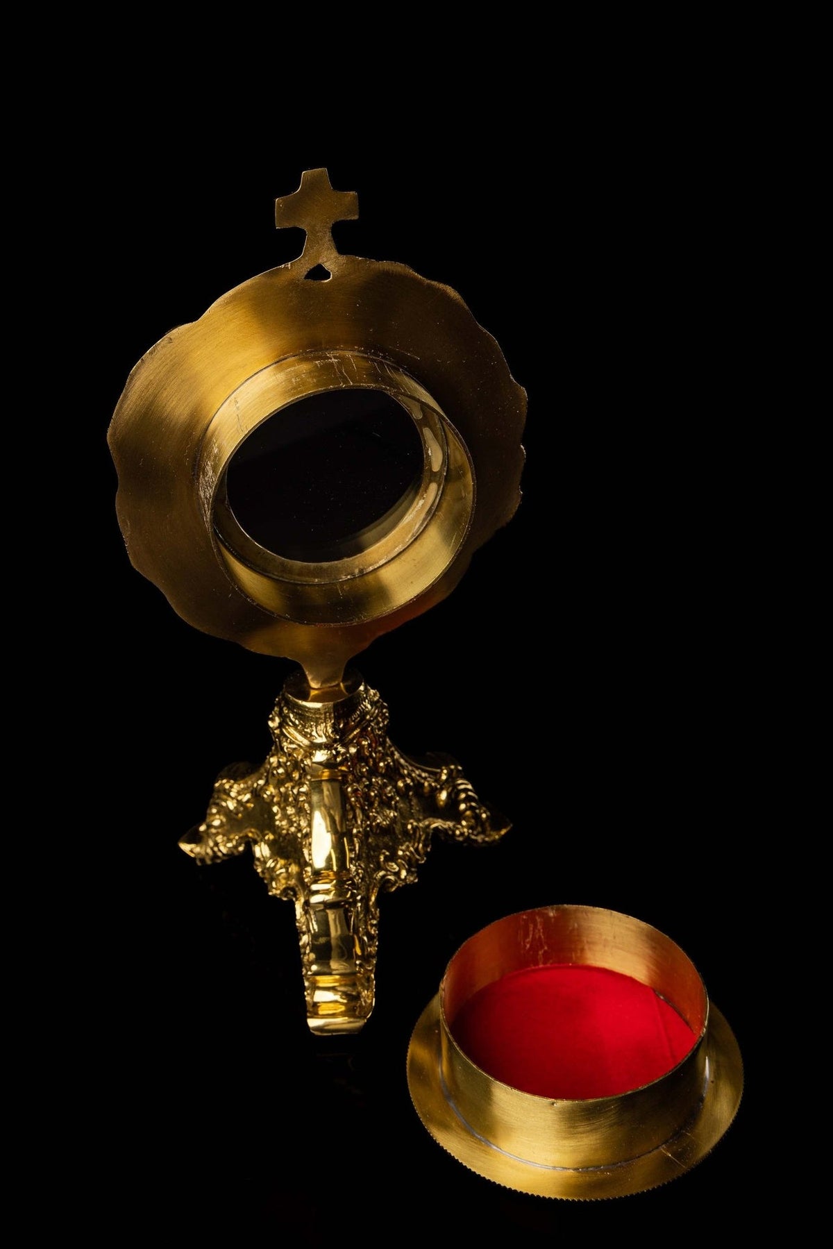 Brass reliquary back view with cross and removable red center