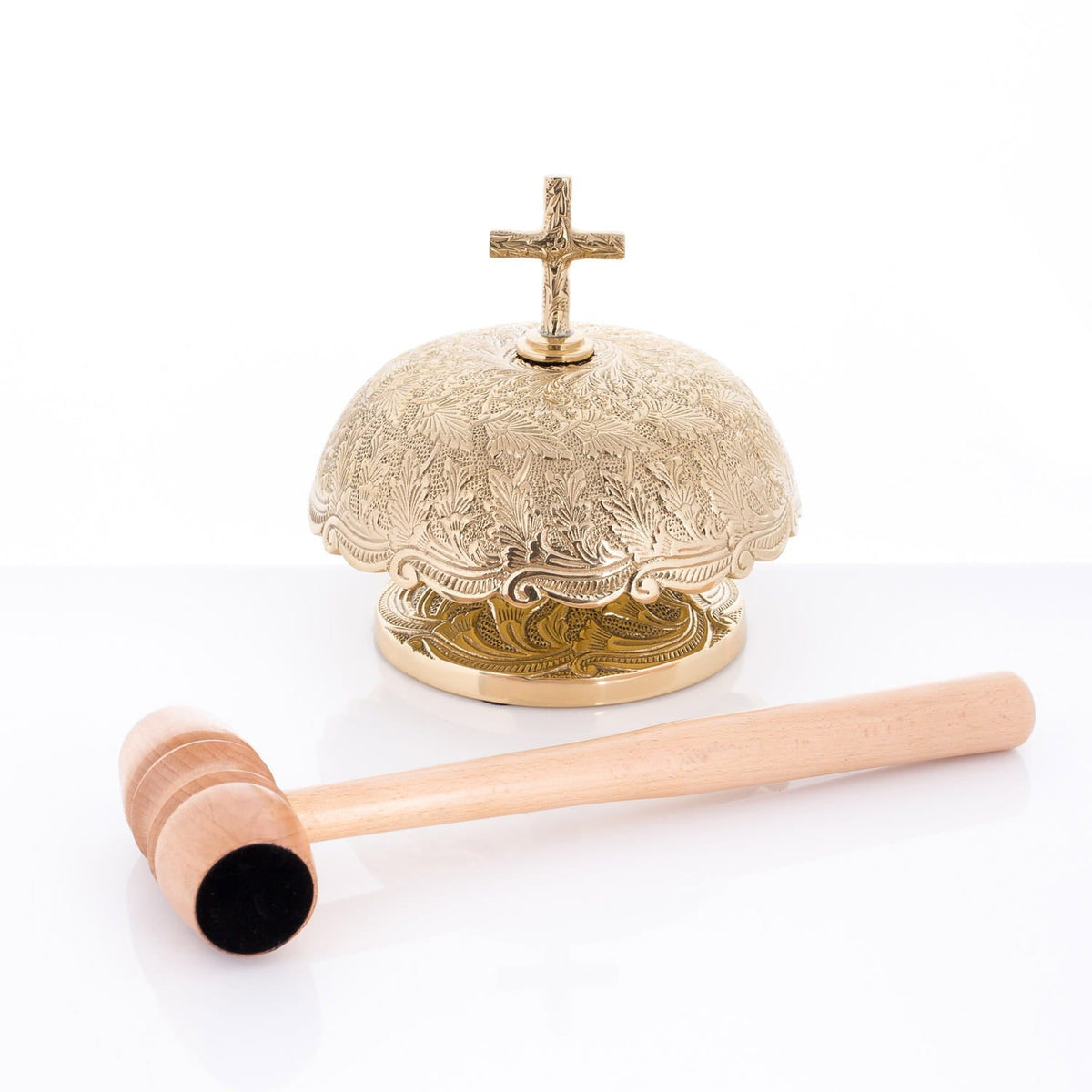 Brass altar bells with wooden mallet, front view showing engraved dome and base