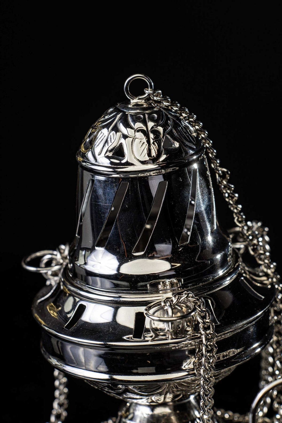 Santiago de Compostela thurible close-up of embossed floral lid and vent openings