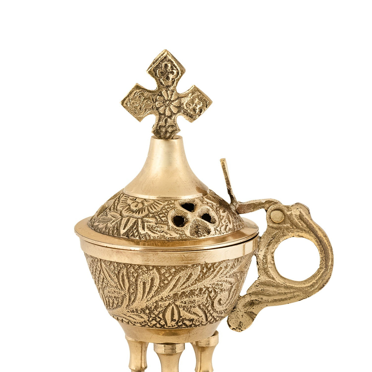 Brass censer close-up showing engraved lid, ventilation holes, handle and cross