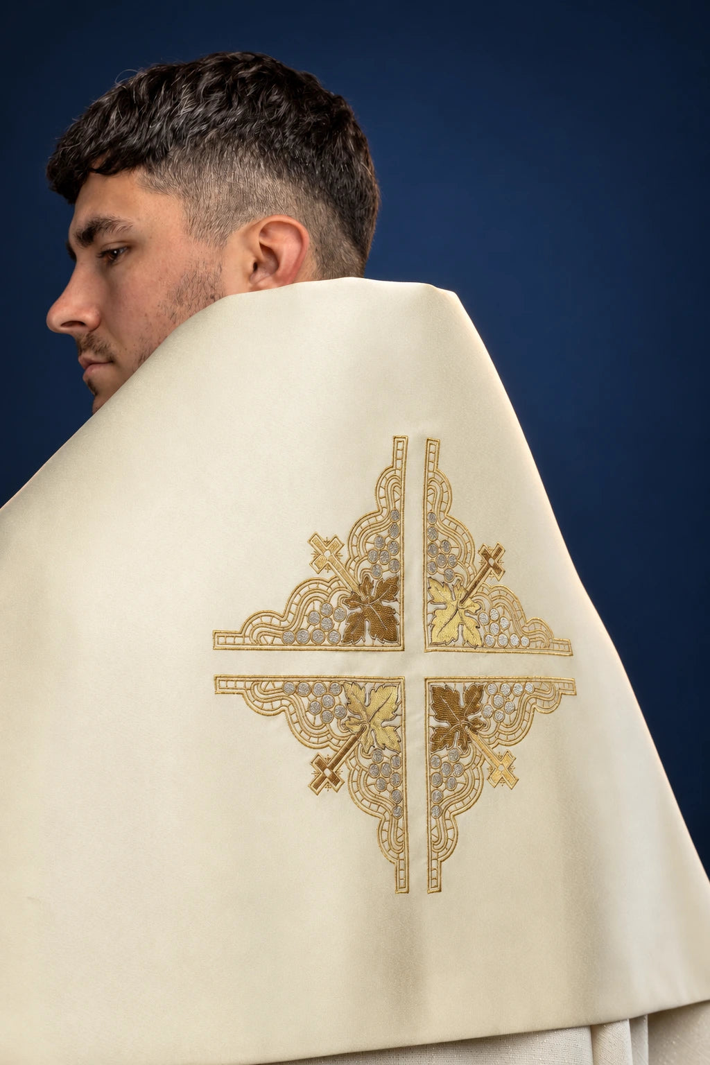 Rear view of an ecru humeral veil with a large embroidered cross motif in gold and silver