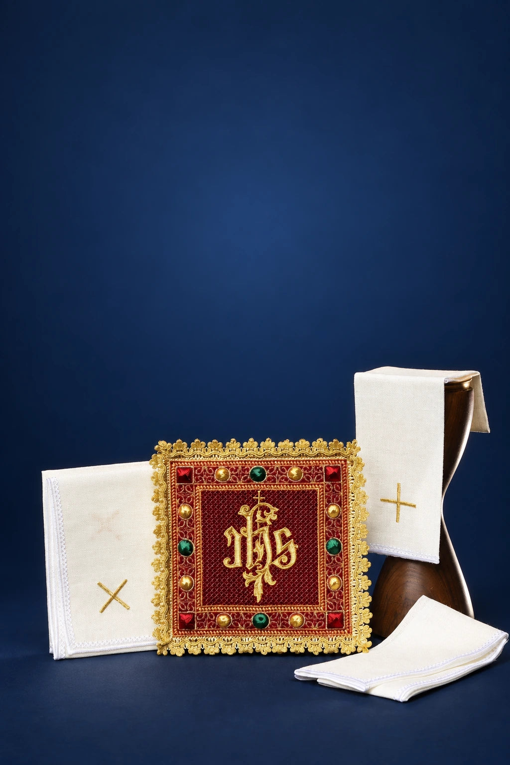Red velvet altar linen set with gold IHS embroidery and gold cross detail on folded linens