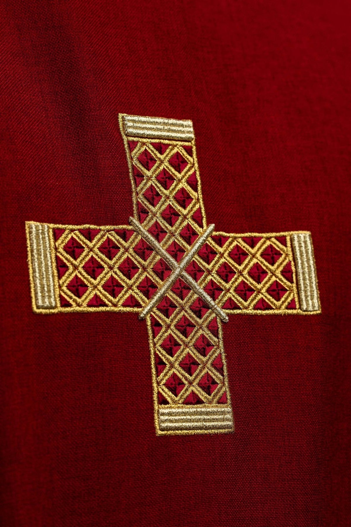 Red dalmatic close-up of embroidered gold cross