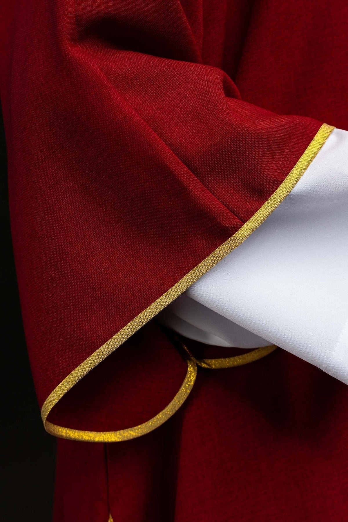 Red dalmatic sleeve with gold edging and white lining