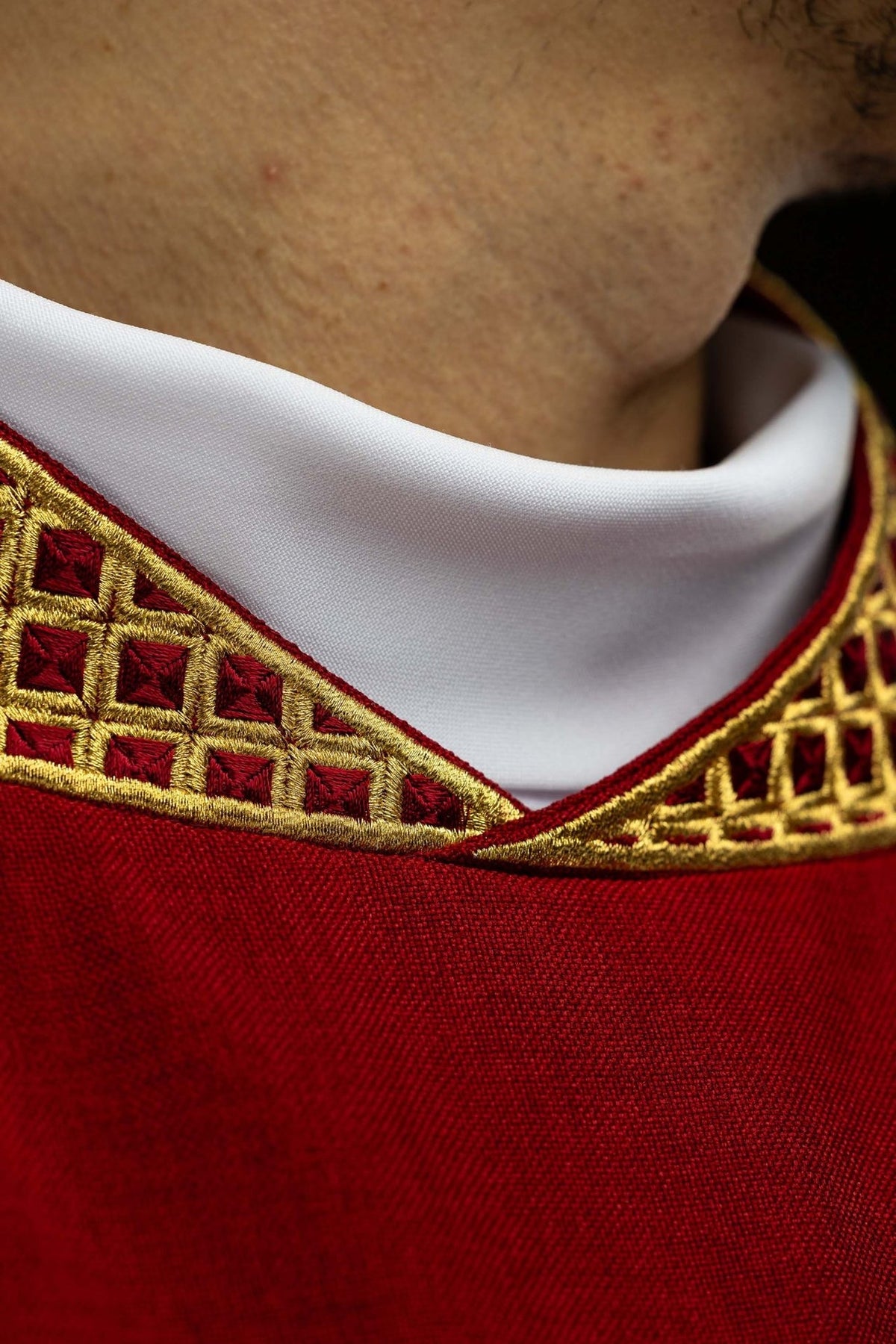 Red dalmatic collar close-up with gold embroidery