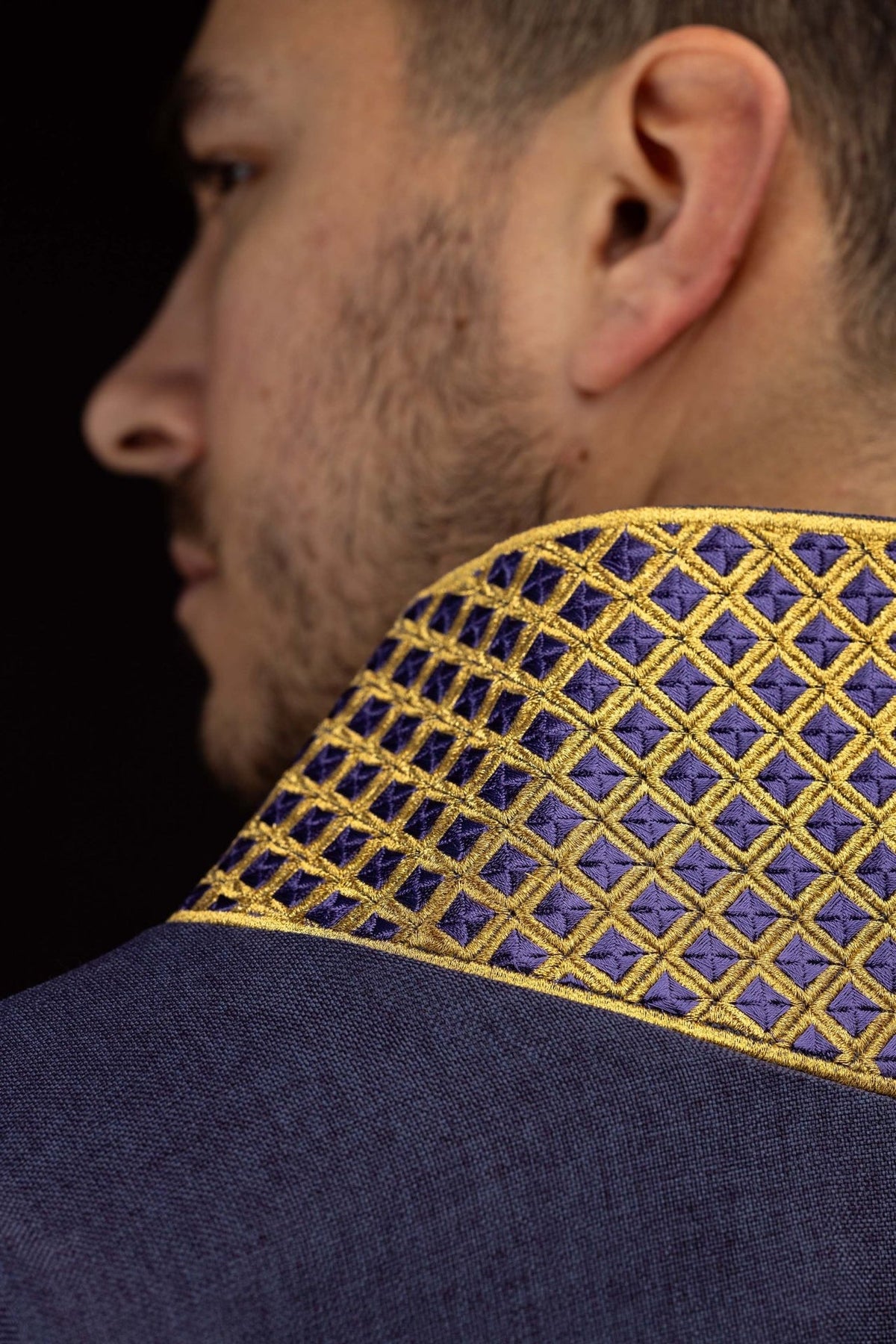 Purple dalmatic collar close-up with gold diamond embroidery