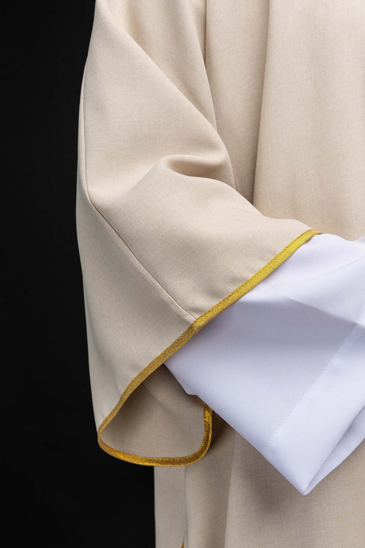 Ecru dalmatic sleeve close-up with gold edging