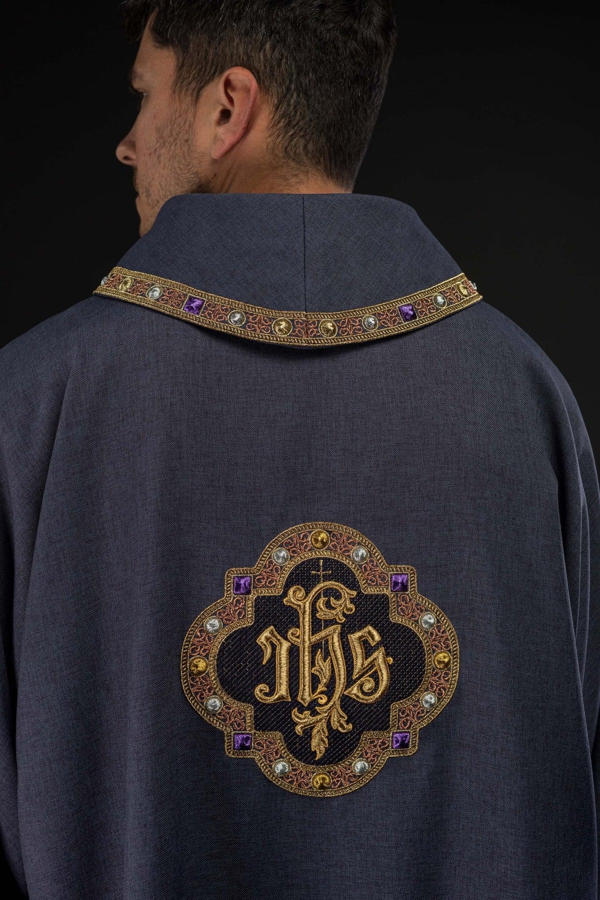 Purple dalmatic back view with embroidered IHS symbol and collar trim