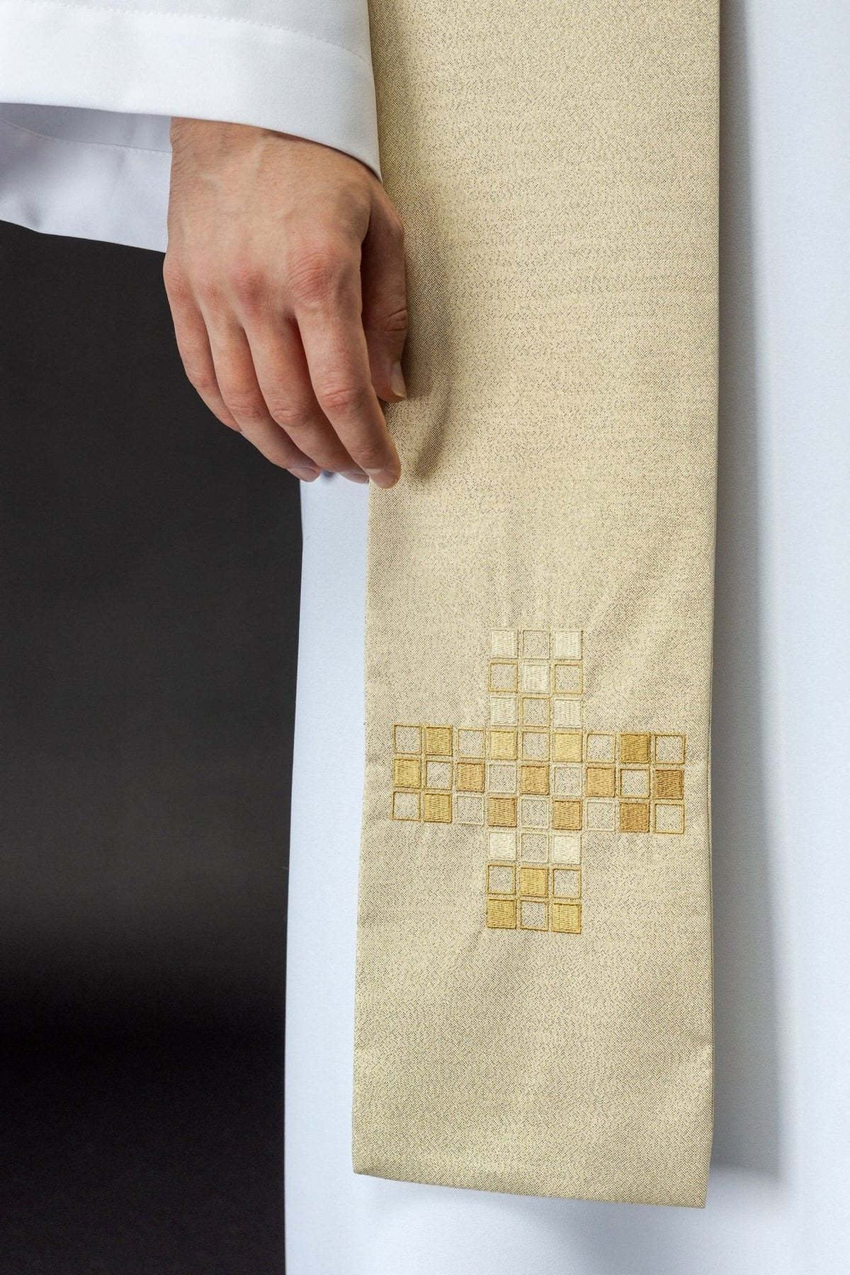 Ecru stole close-up showing gold geometric cross embroidery