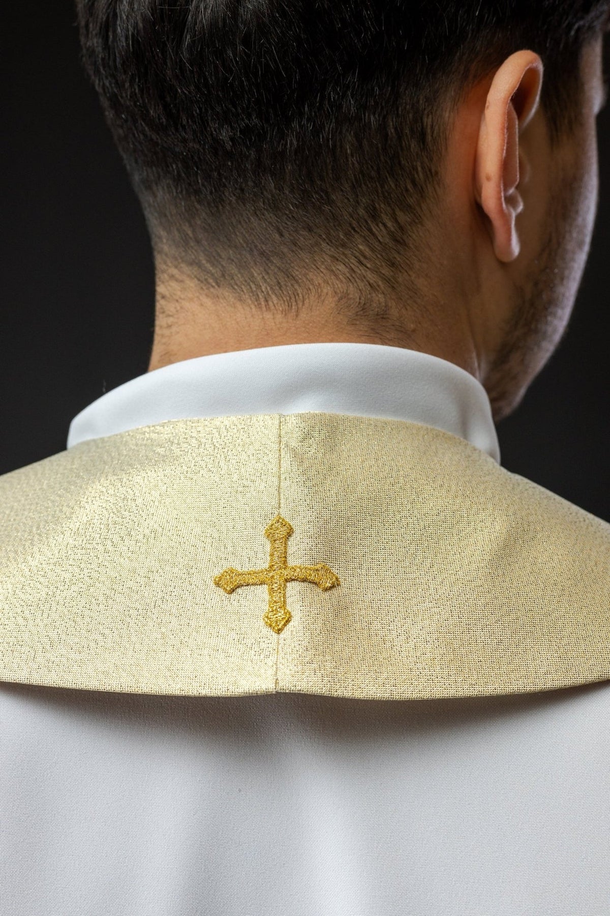 Ecru stole back close-up with a gold embroidered cross at the neck