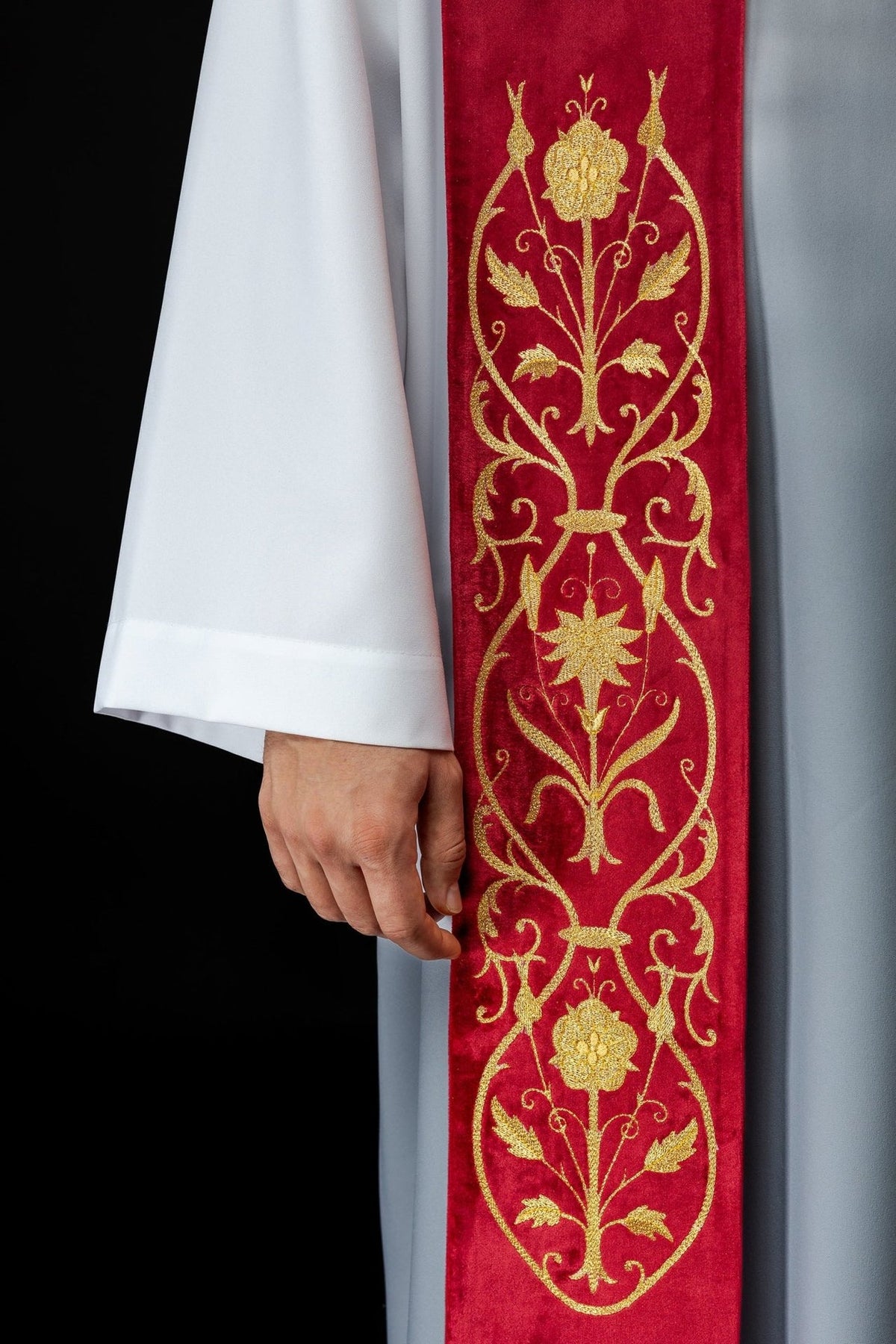 Red stole close-up showing embroidered gold floral embroidery
