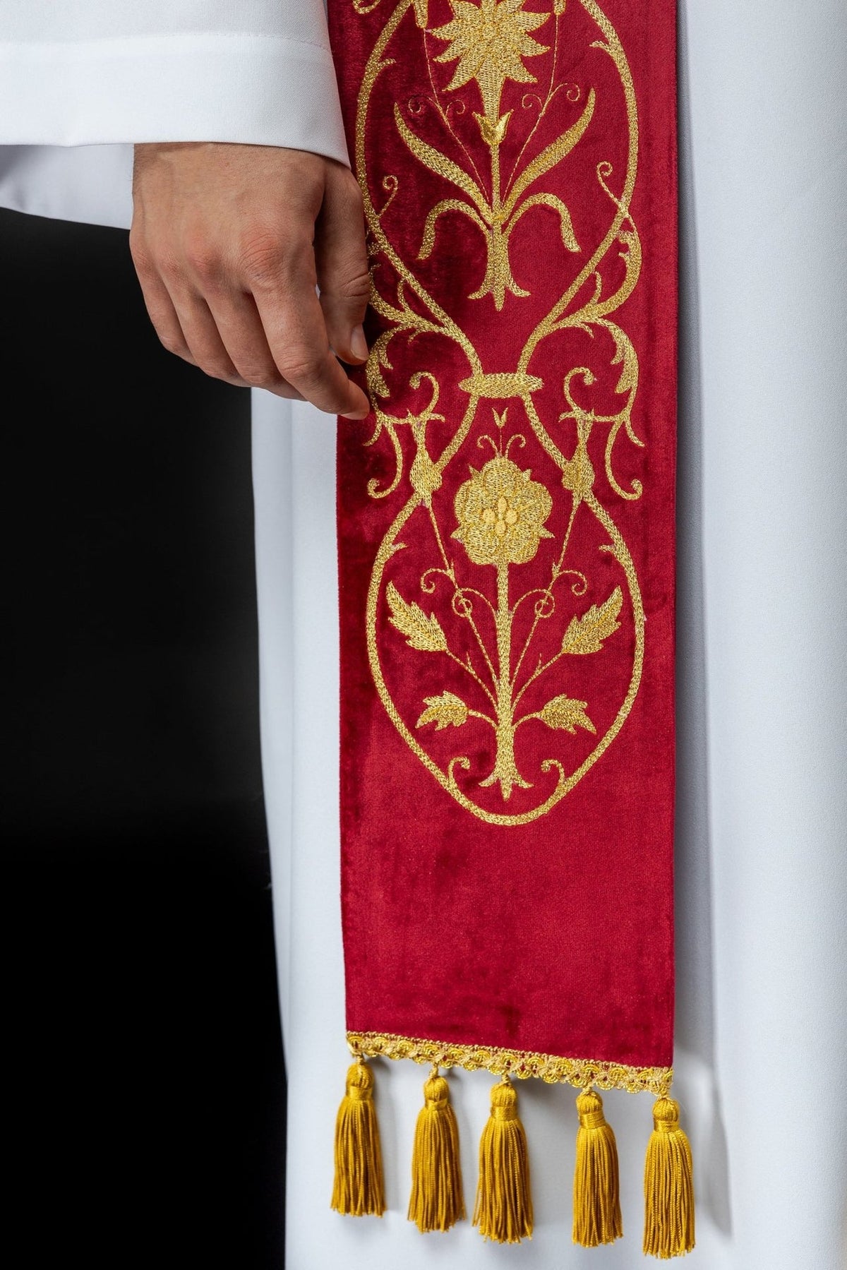 Red stole detail showing gold floral embroidery and lower tassel trim
