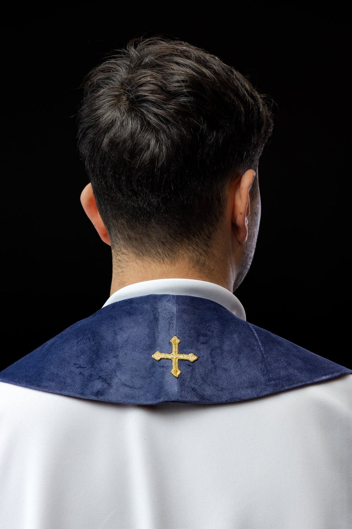 Purple stole back view worn with an embroidered gold cross