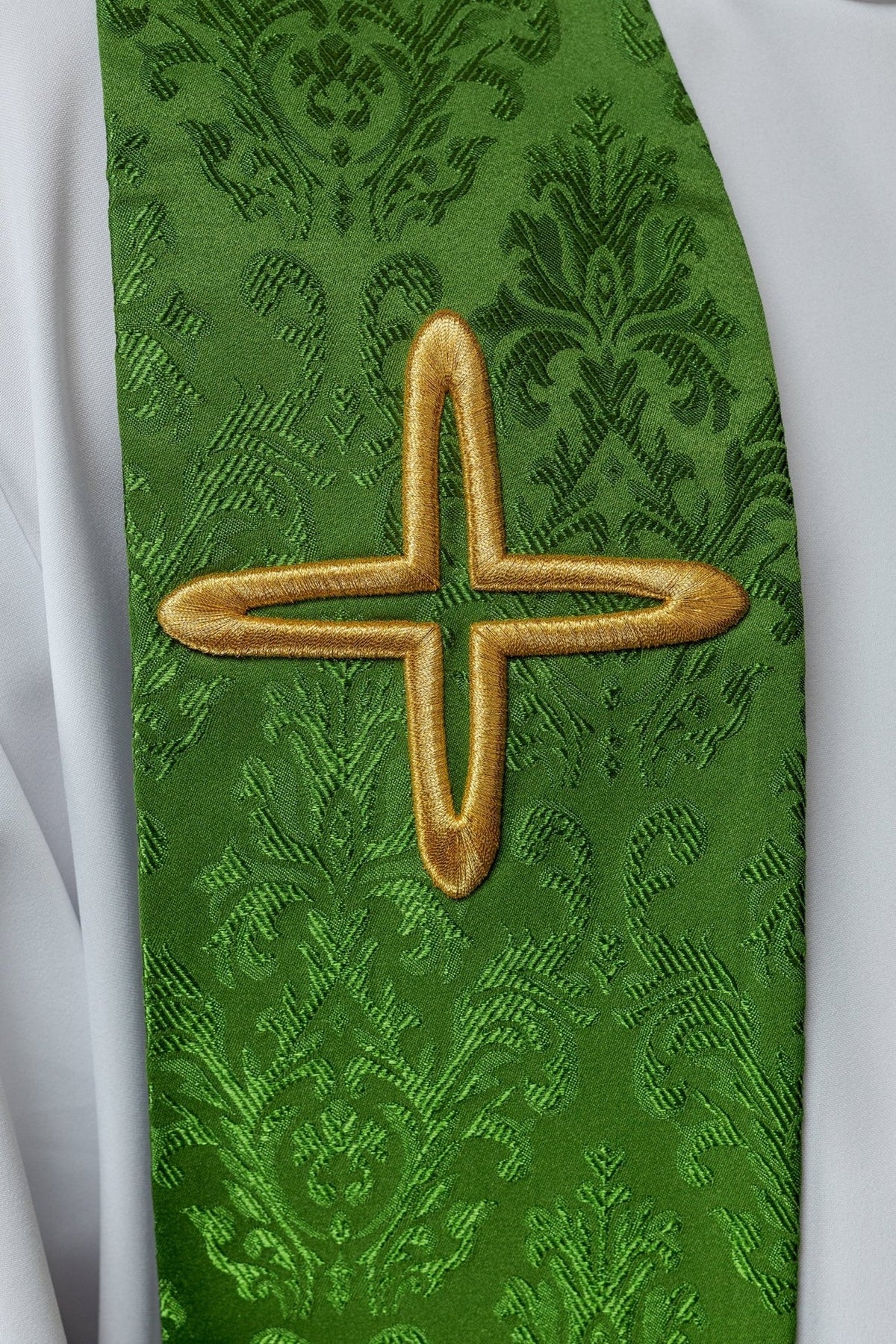 Green embroidered jacquard stole, close-up of gold cross embroidery and floral pattern