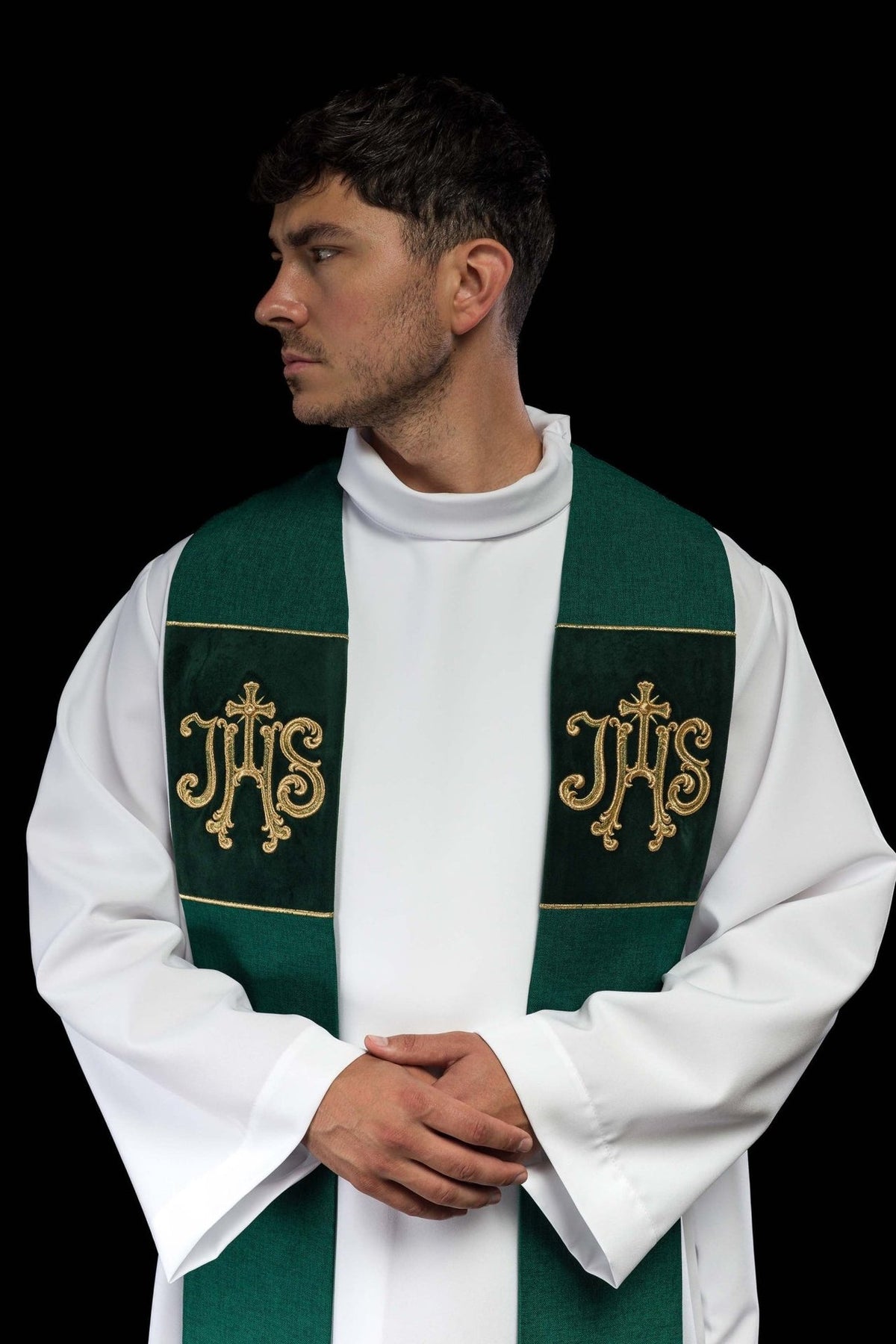 Green velvet stole worn close-up showing gold embroidered IHS motifs