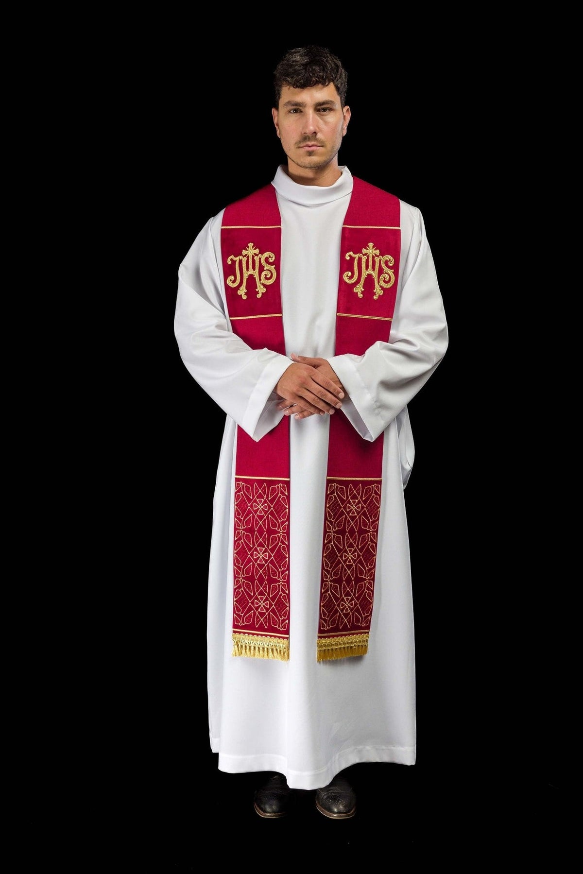 Red velvet stole, full front view showing IHS embroidery, patterned ends and fringe