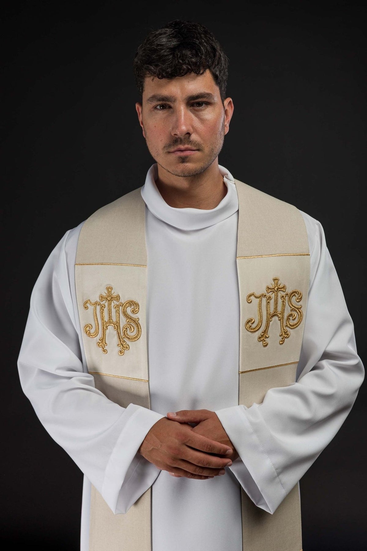 Ecru velvet stole worn front, showing gold IHS embroidery and trim