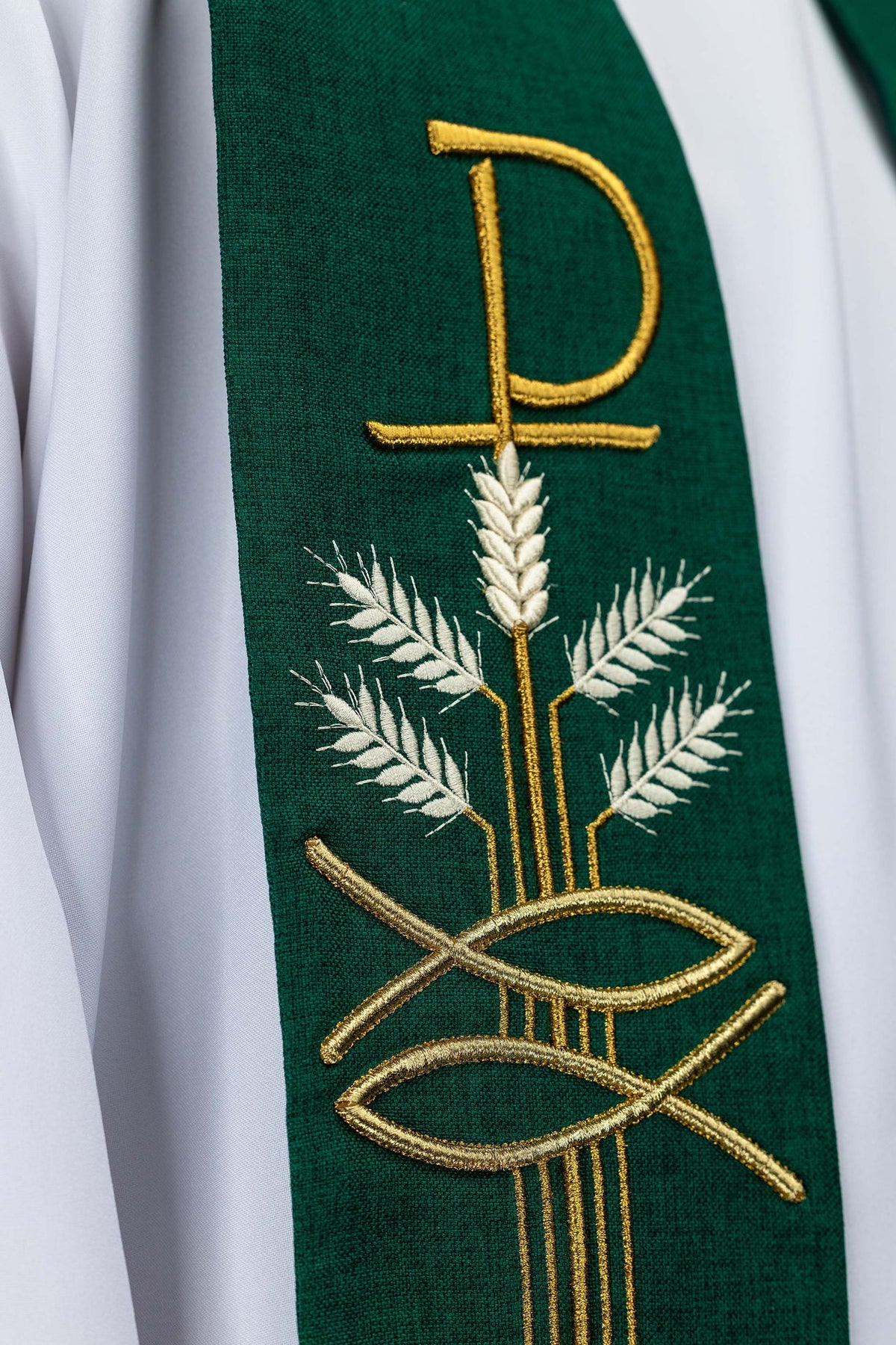 Green stole close-up showing Pax, fish, and wheat embroidery