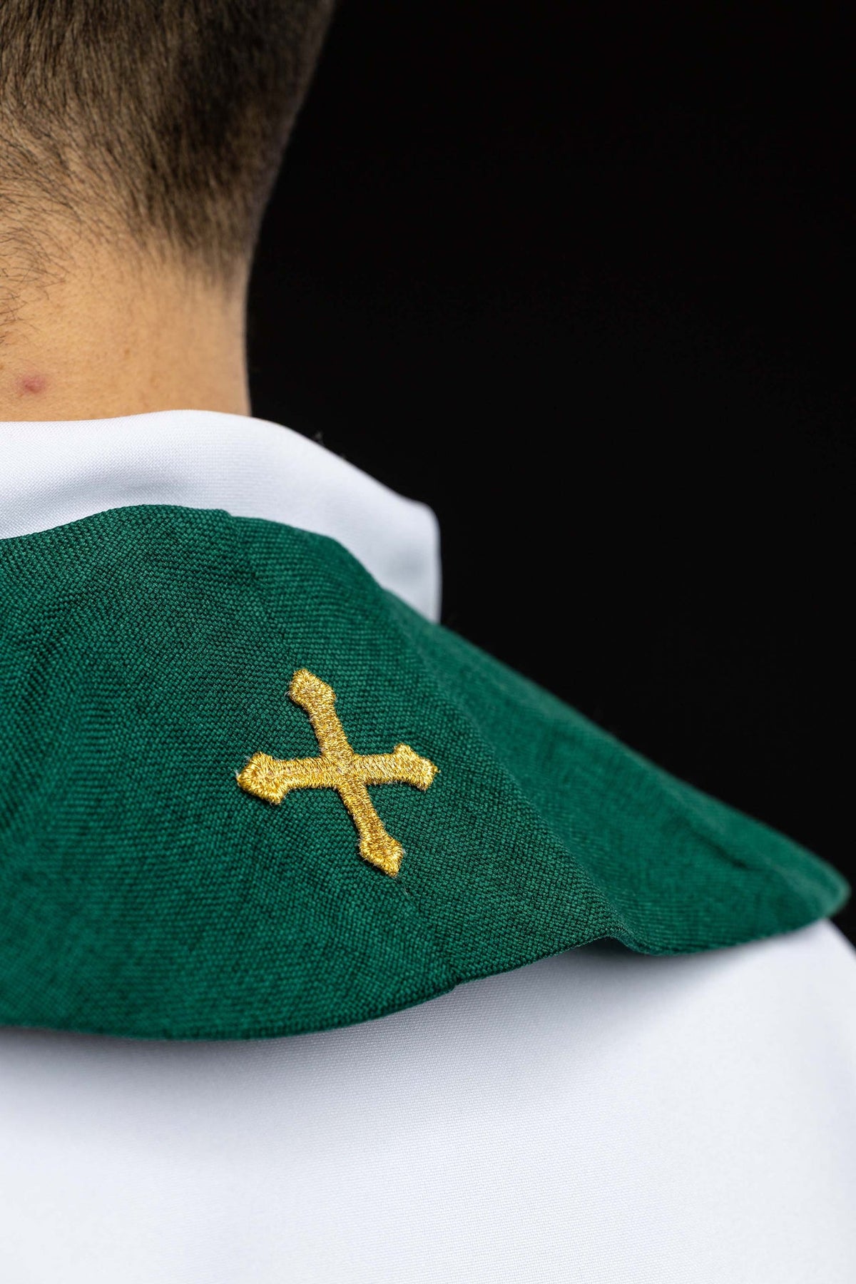 Green stole detail showing cross, fish, and wheat embroidery