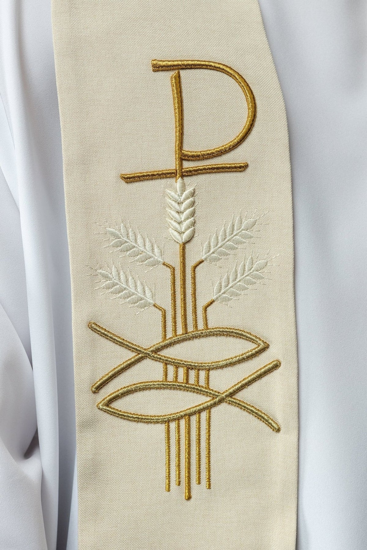 Ecru stole embroidery detail showing Pax, fish, and wheat motifs