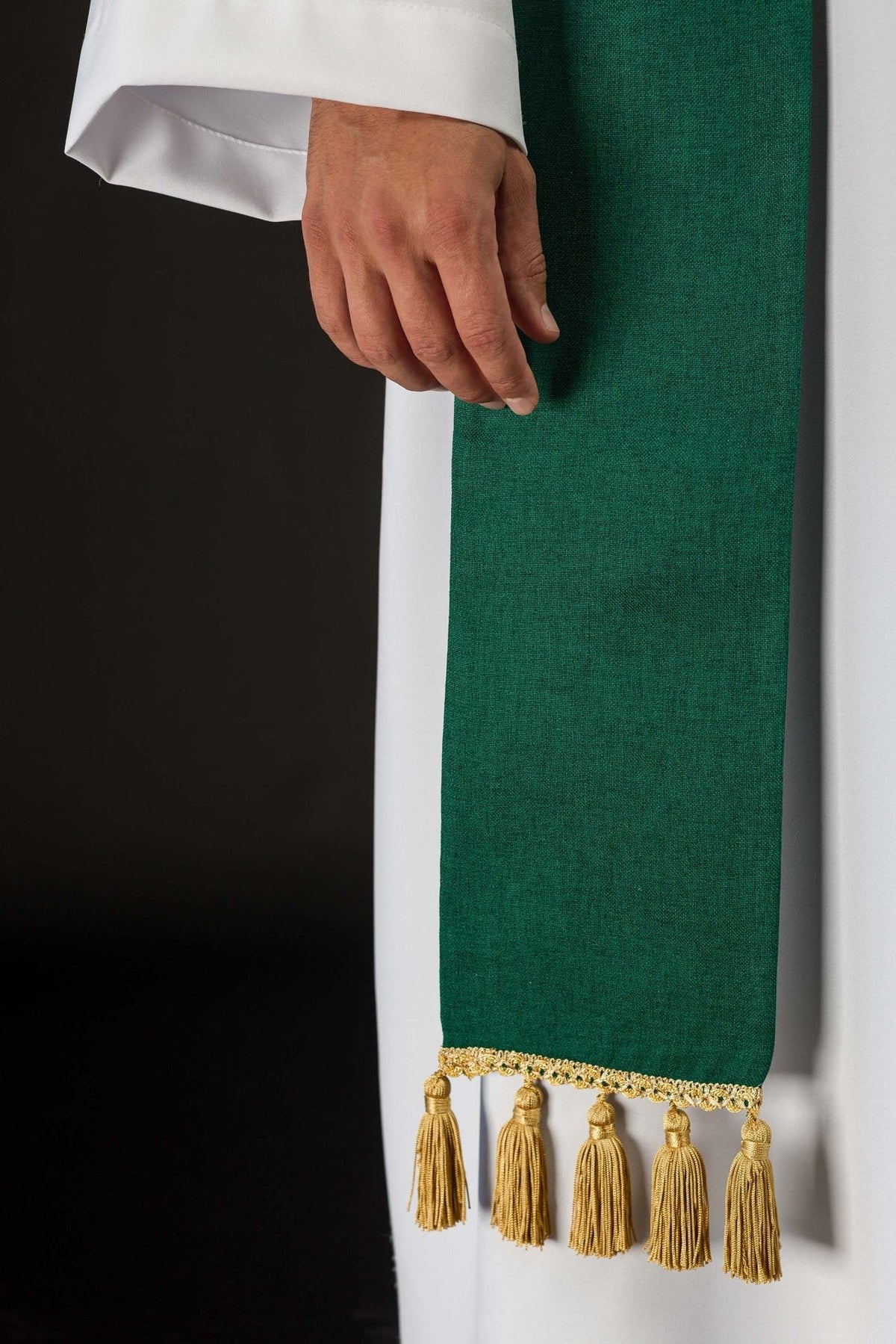 Green stole side detail with gold fringe and polyester fabric