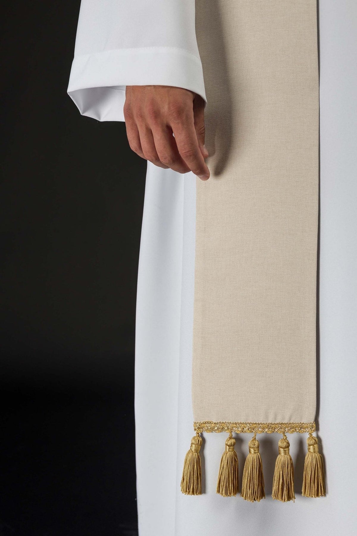 Ecru stole side detail showing plain fabric and gold tassel fringe