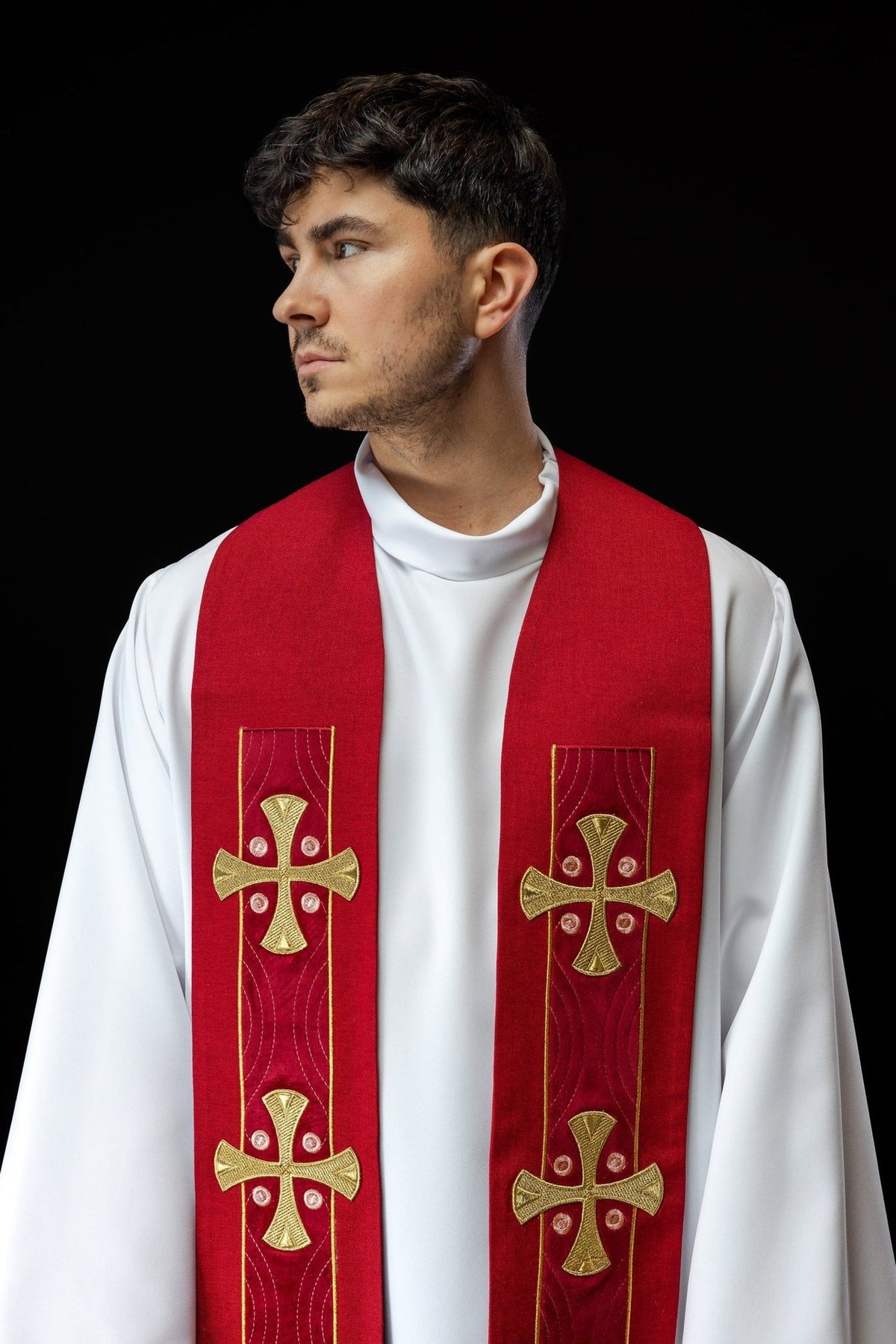 Red embroidered stole close-up worn front view with gold crosses and curved embroidery