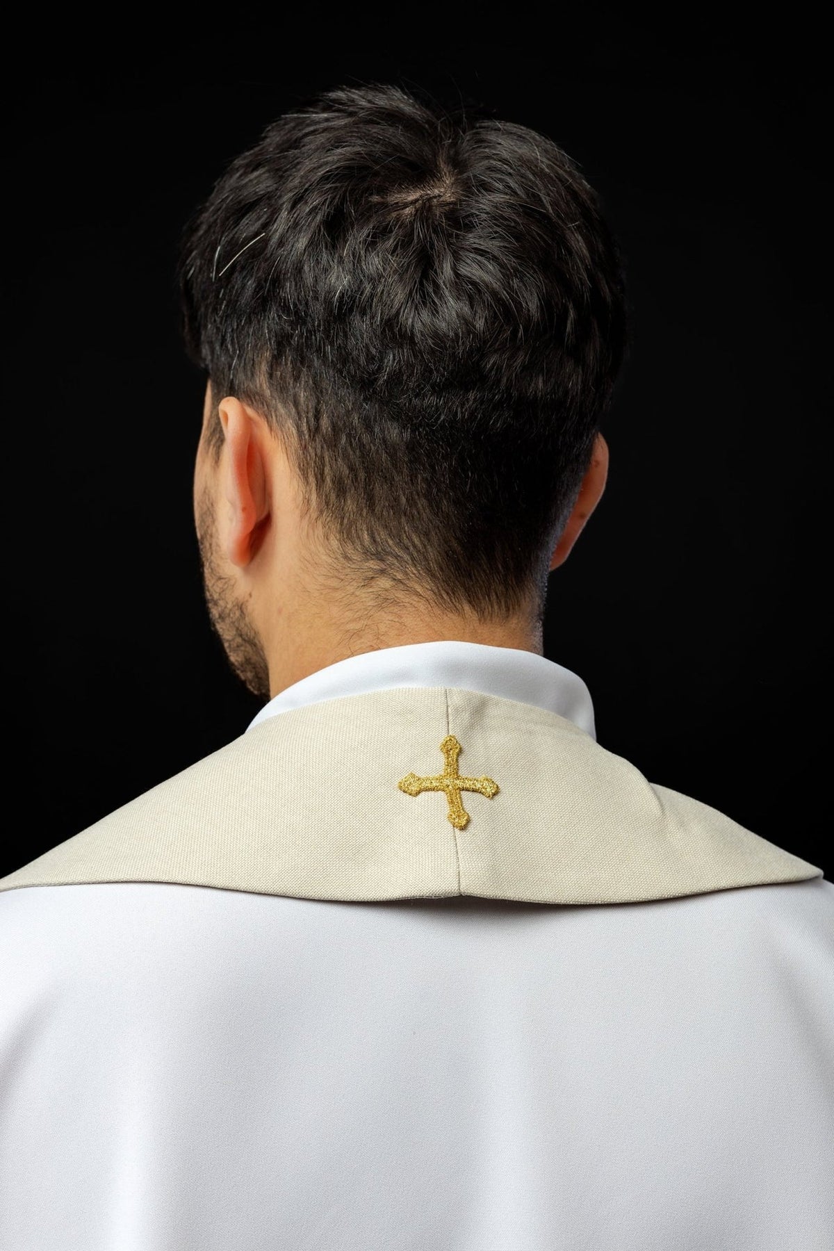 Ecru stole back view worn with a small gold cross at the neck