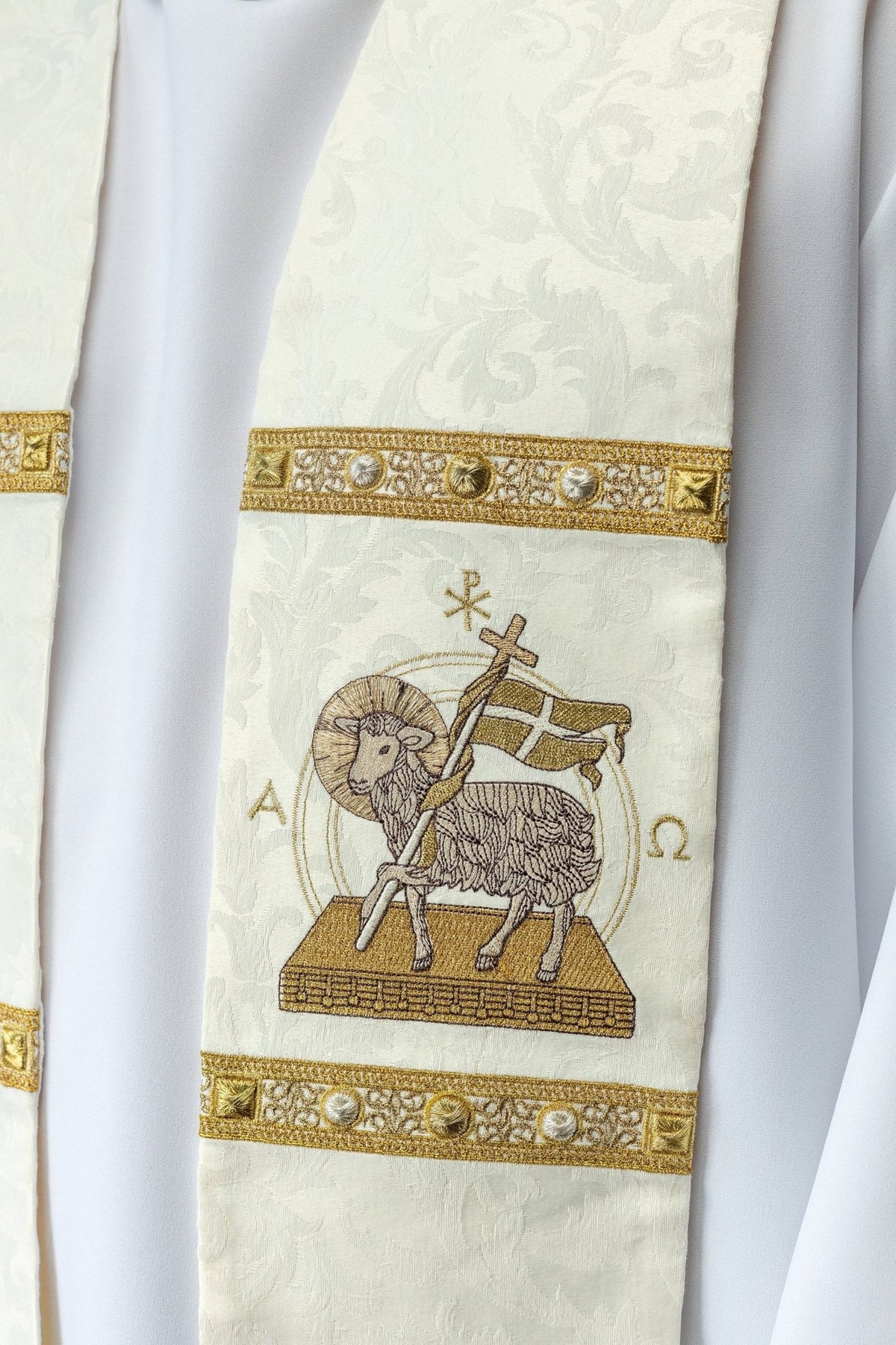 Stole close-up showing Paschal Lamb embroidery, gold decorative bands and jacquard fabric