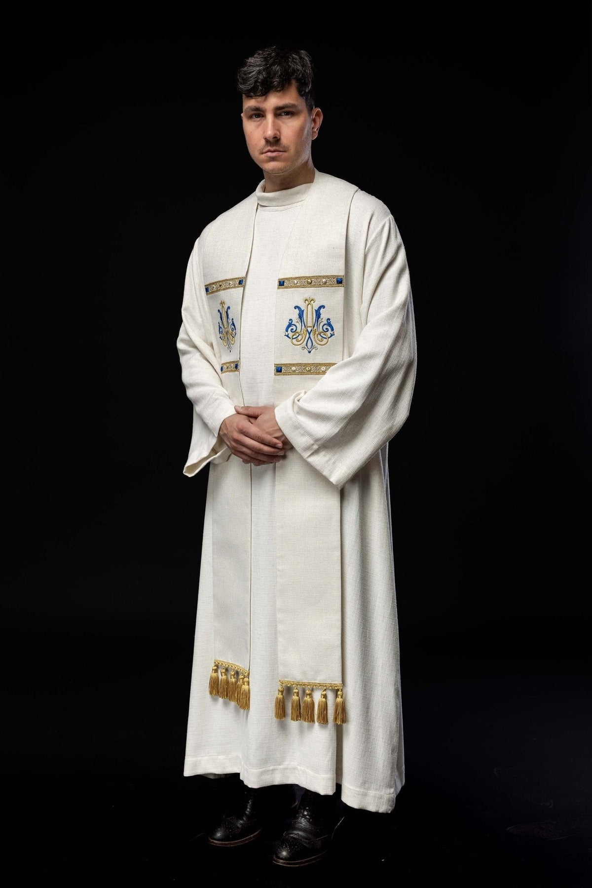 Ecru stole worn at an angle showing Marian embroidery and gold tassels
