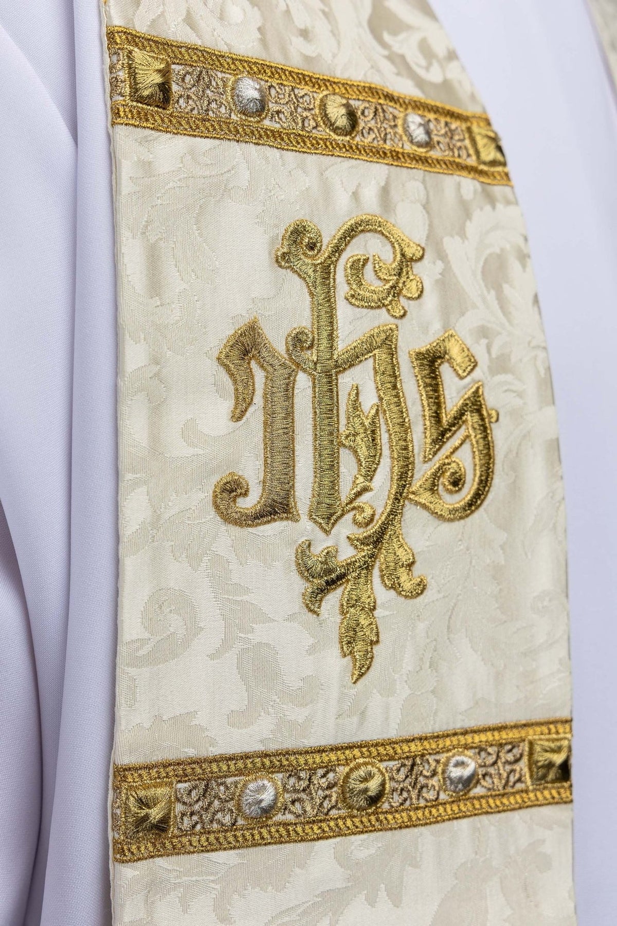 Stole close-up showing gold embroidered IHS monogram and decorative orphrey