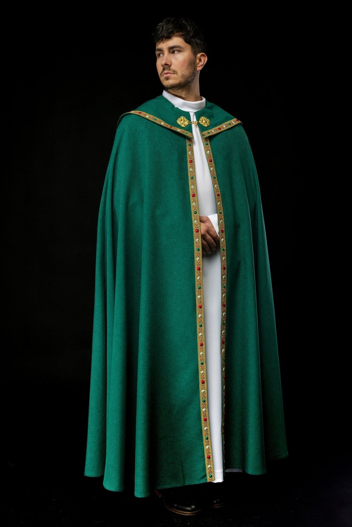 Green cope front view with gold embroidered trim and decorative clasp