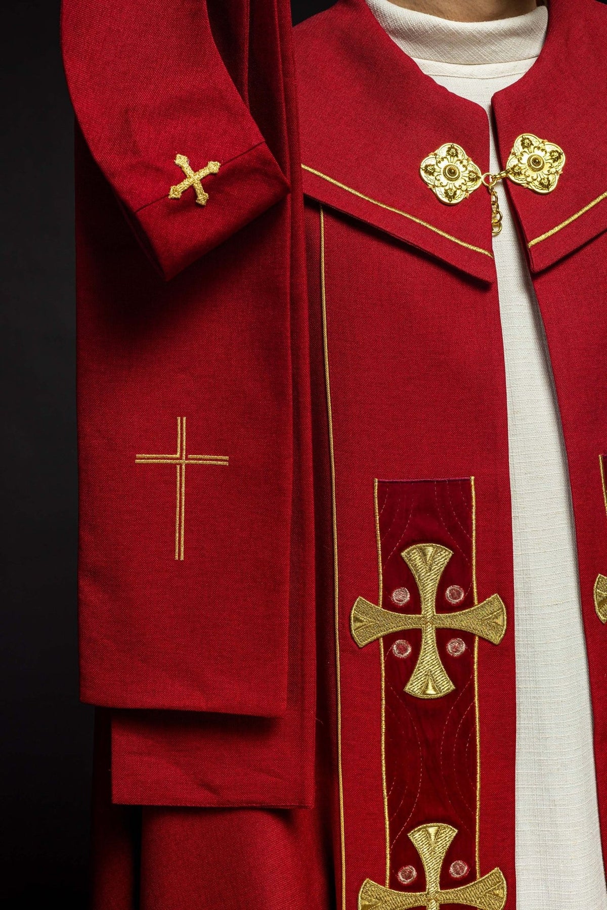 Red cope front detail with embroidered gold crosses on velvet panels