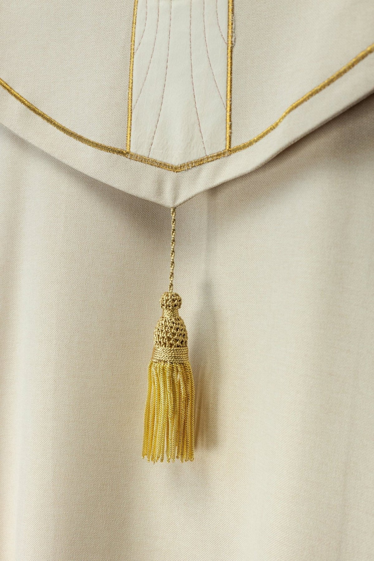 Ecru velvet cope, close-up of gold tassel and embroidered trim