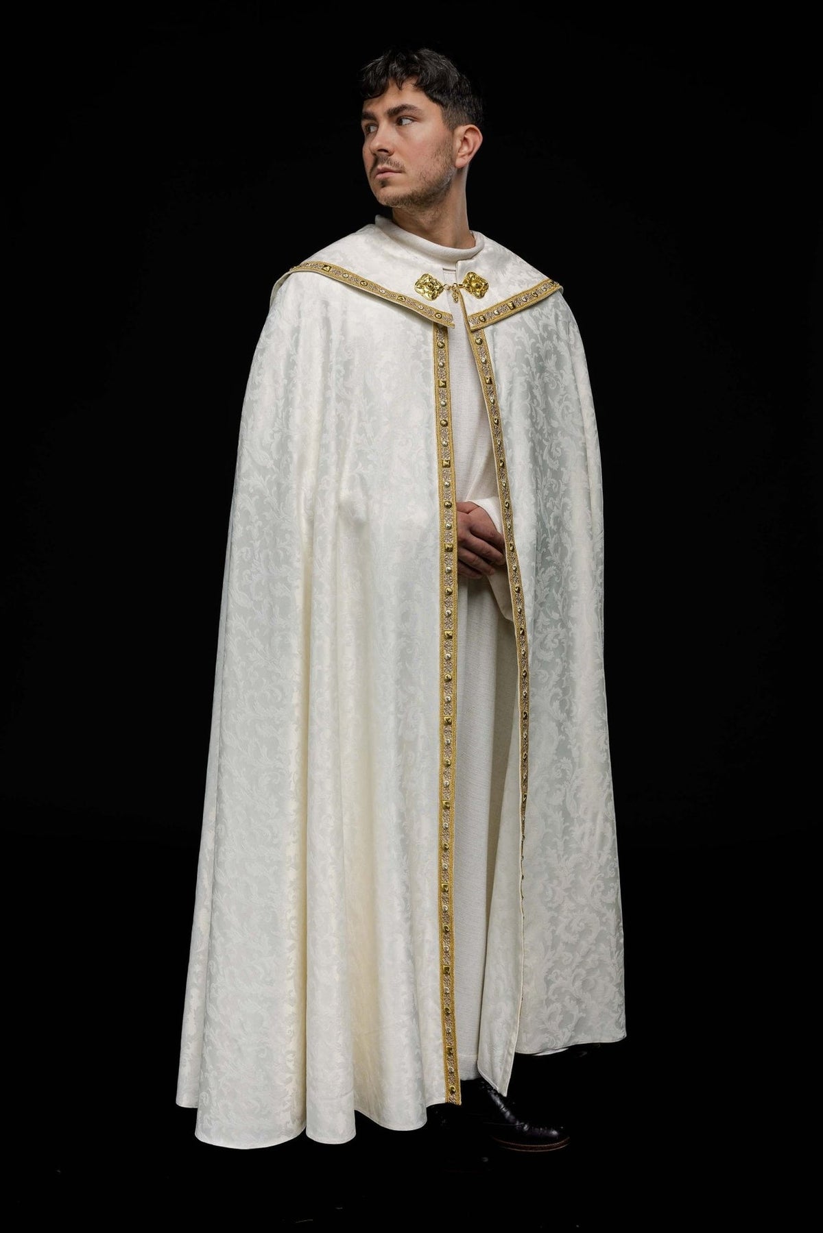 Ecru cope front view with jacquard floral pattern, gold trim and clasp