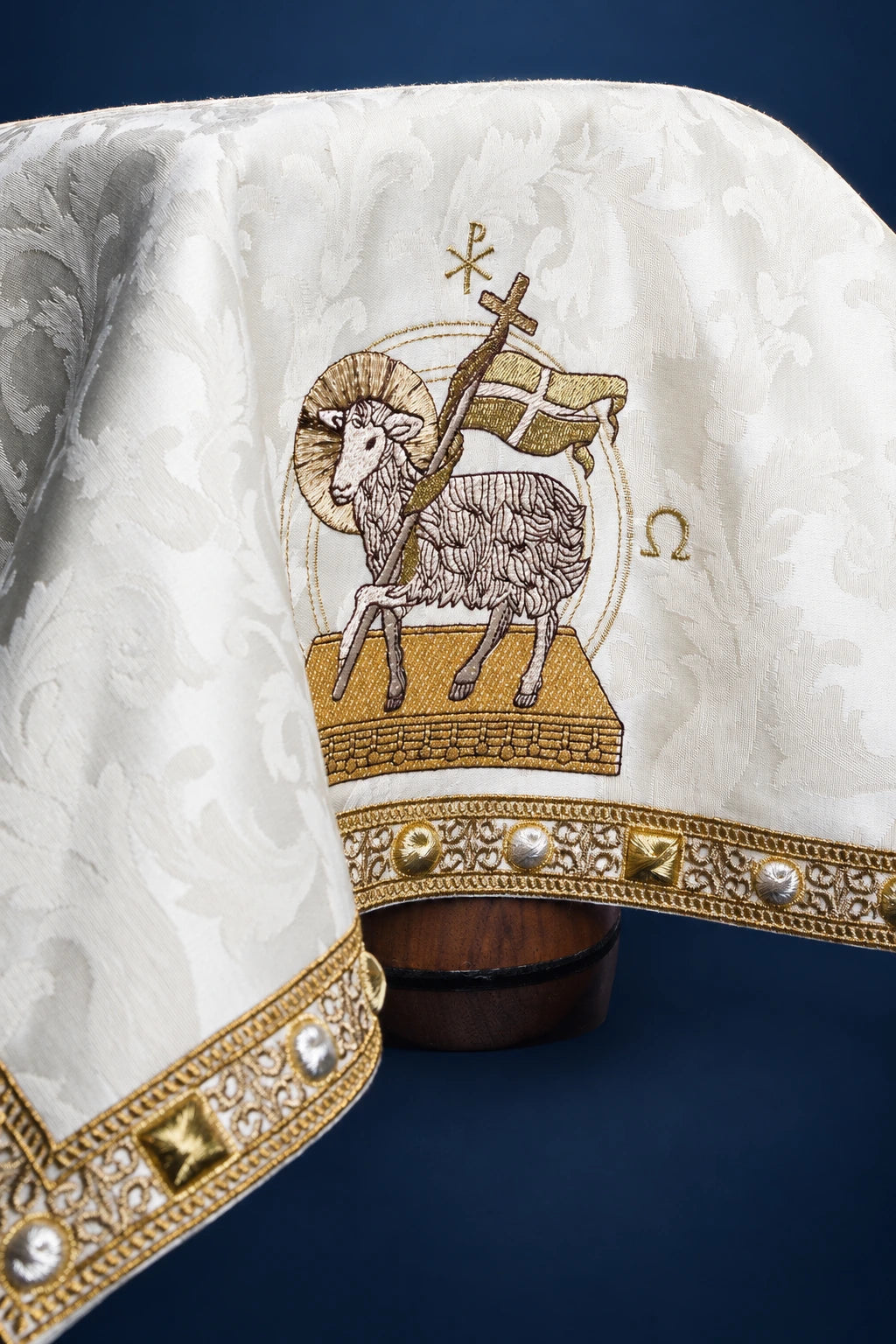 Chalice veil with Paschal Lamb embroidery in ecru jacquard fabric, draped view with gold trim