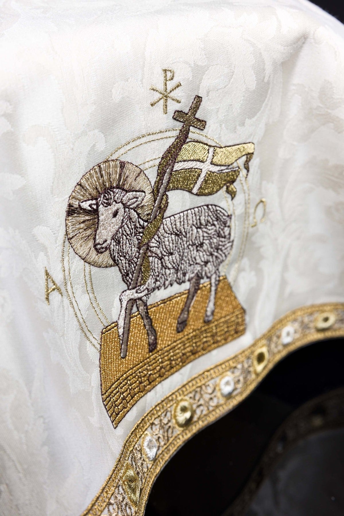 Chalice veil close-up showing Paschal Lamb embroidery, Alpha Omega symbols and gold trim