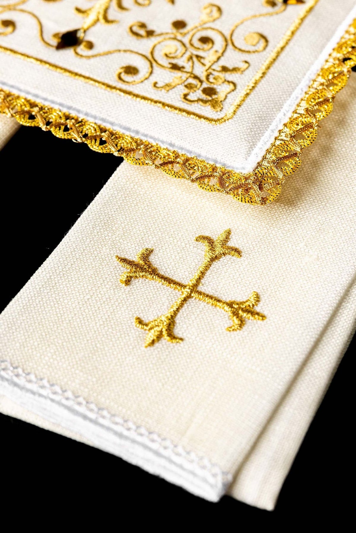 Altar linen set detail showing gold cross embroidery and ornate gold edging