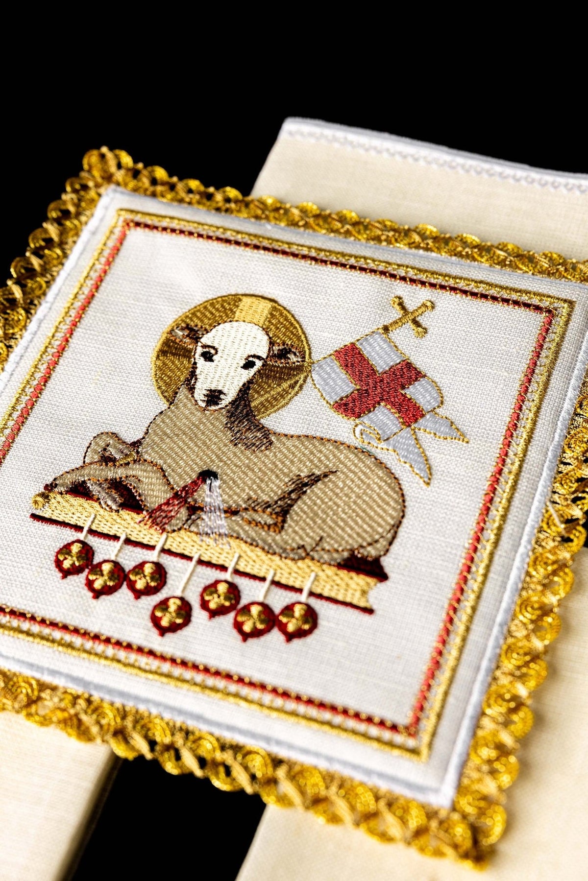 Altar linen set close-up with lamb, red and gold embroidery, and ornate gold trim