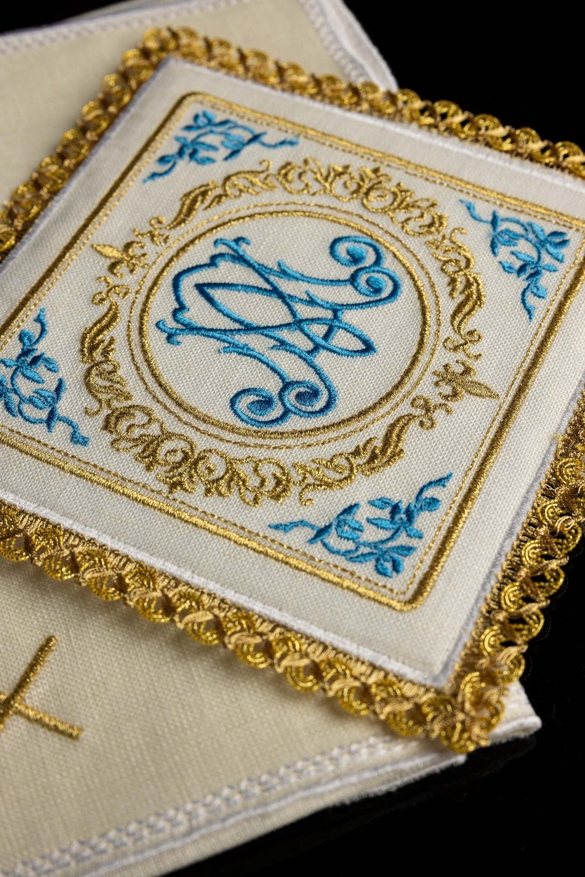 Altar linen set close-up with blue Marian motif embroidery, gold ornament and scalloped trim