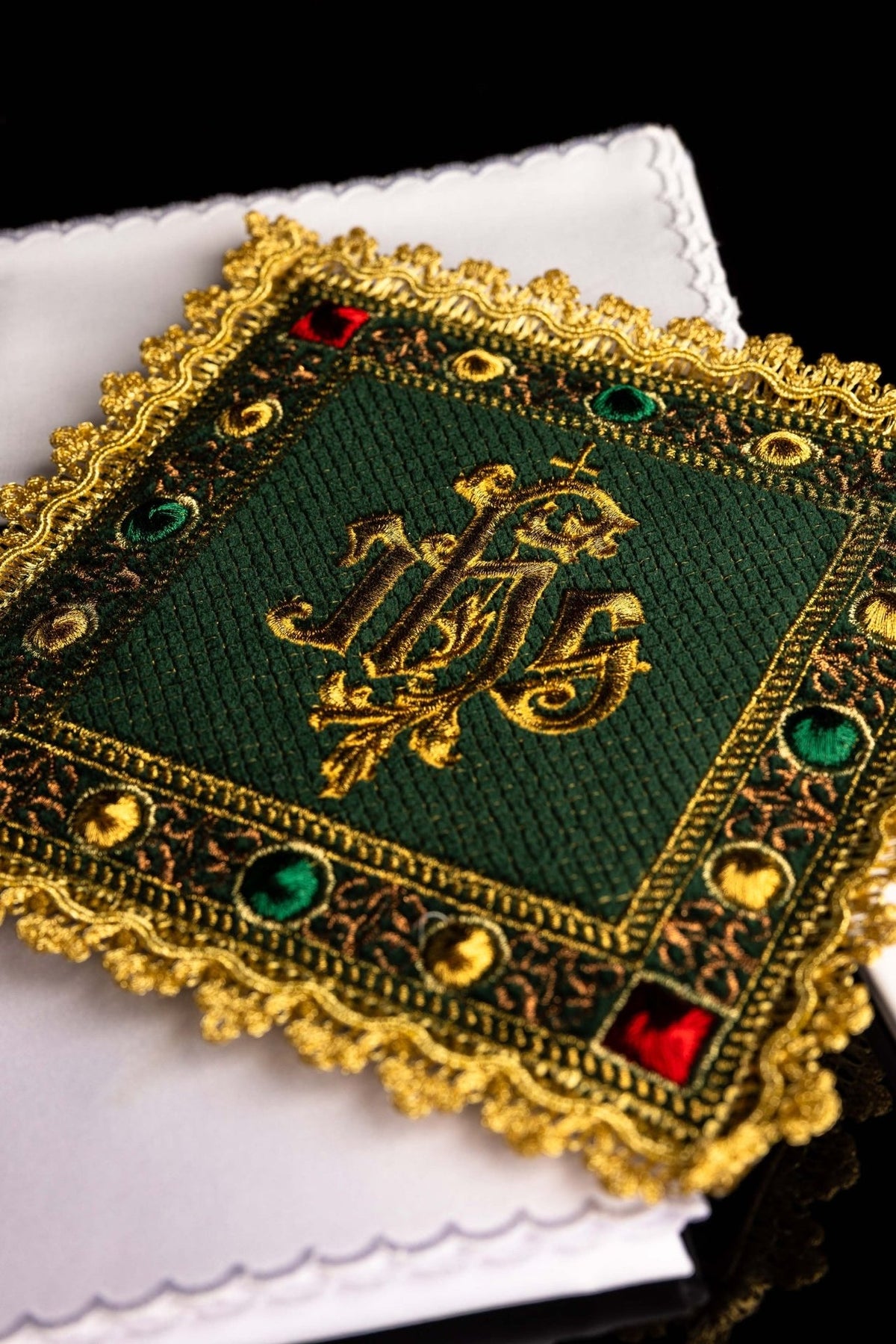 Green velvet altar linen set close-up showing embroidered IHS symbol, gold trim and white cloth