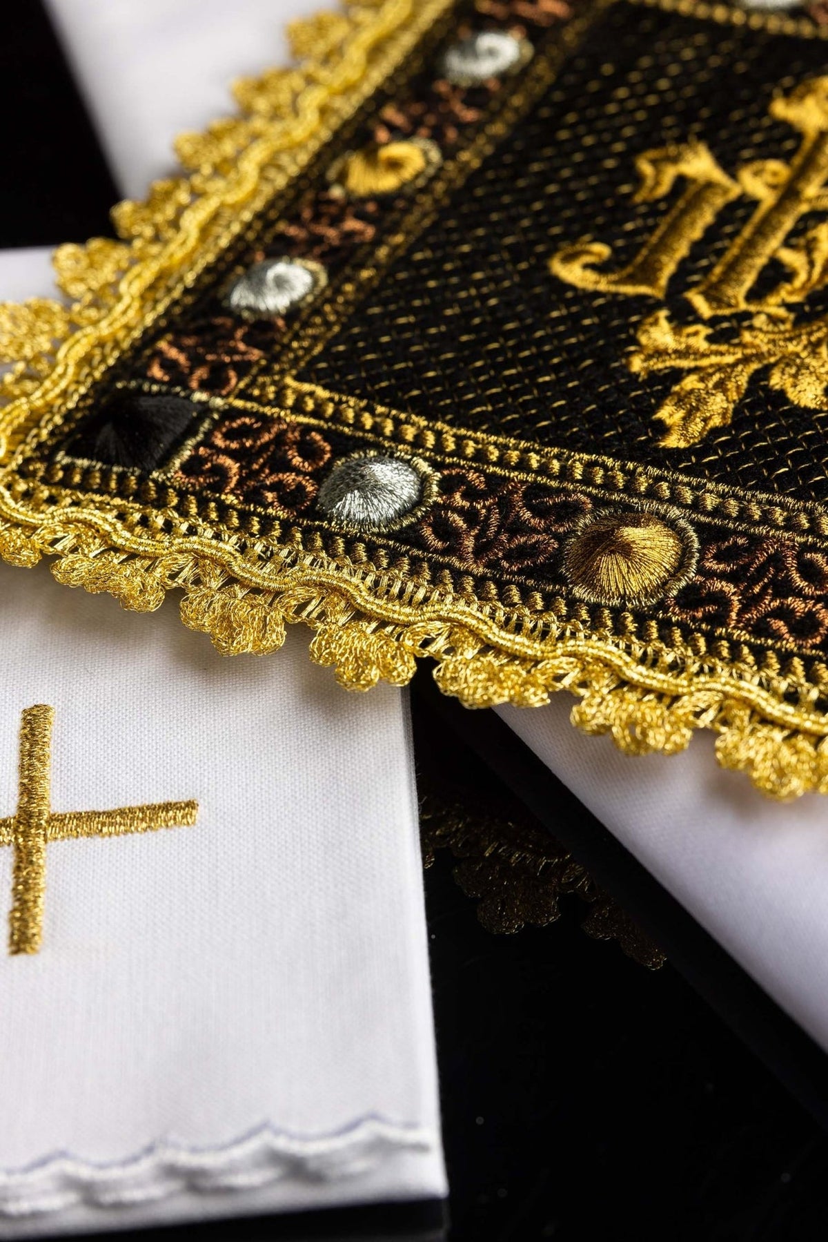 Chalice pall close-up showing black velvet, gold embroidery, ornate trim and raised decorative motifs
