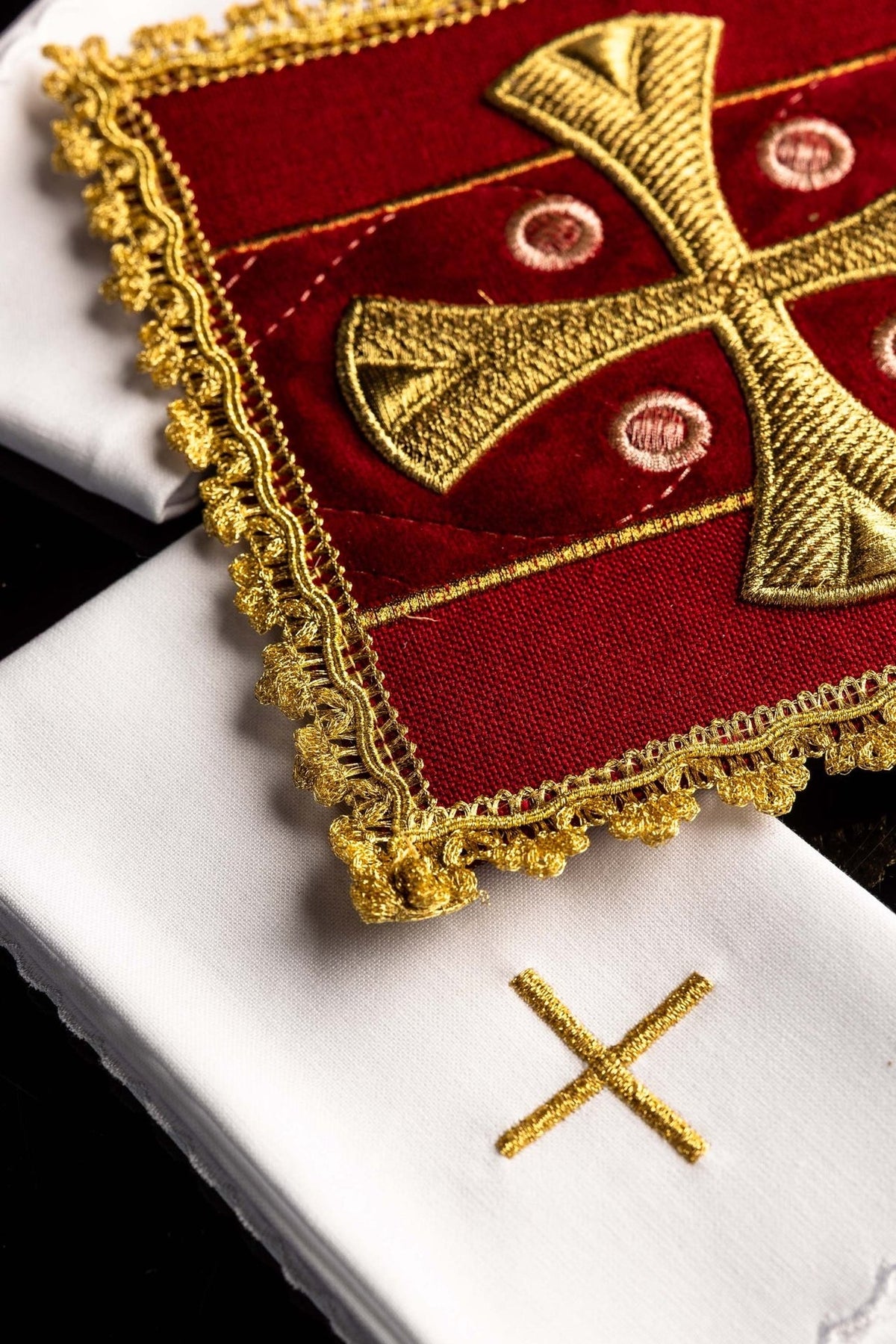 Altar linen set detail with red corporal, gold cross embroidery and white linen