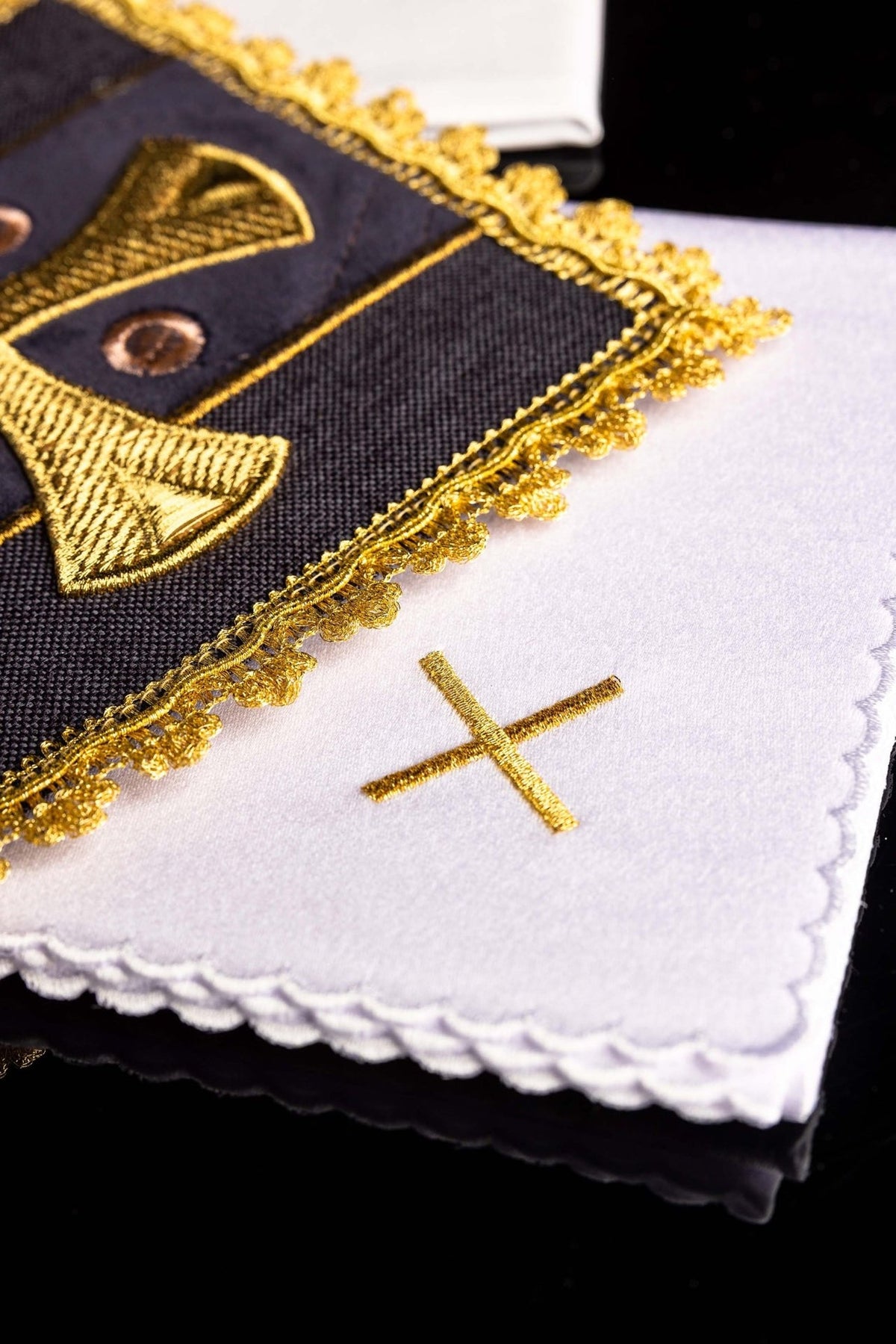 Altar linen set detail showing gold cross embroidery, purple velvet and scalloped white linen edge