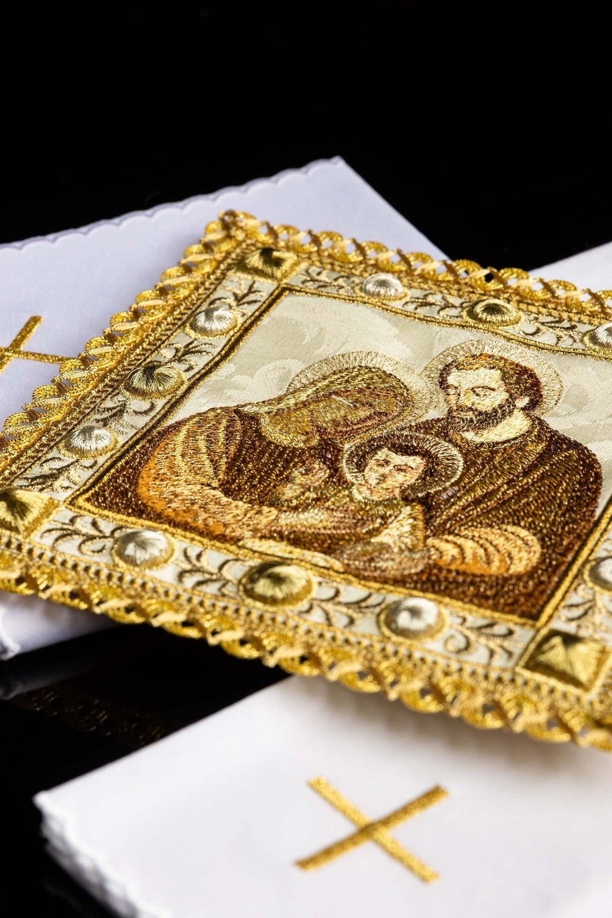 Altar linen set close-up showing white linen with embroidered gold cross