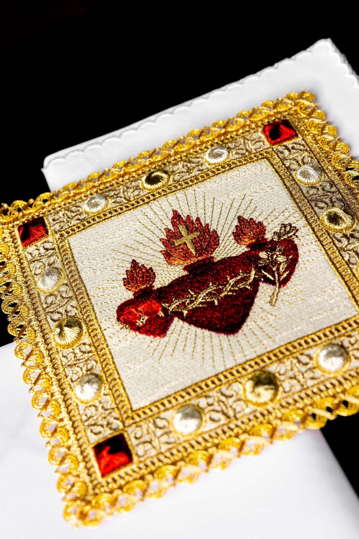 Altar linen set close-up showing embroidered Sacred Heart of Jesus, Heart of Mary and cross
