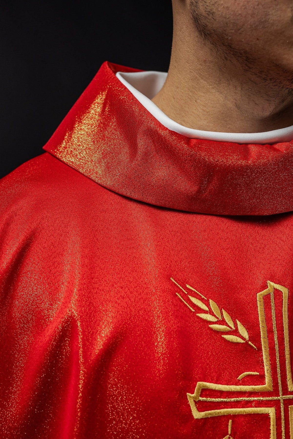 Red chasuble, close-up of stand-up collar and gold cross embroidery