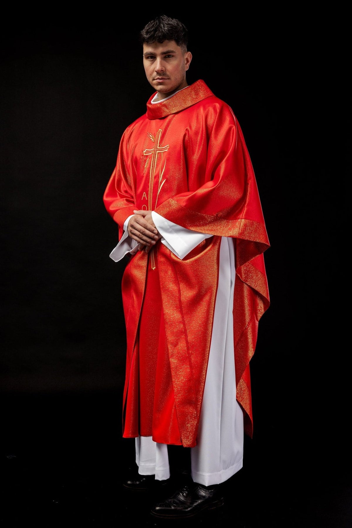Red chasuble, angled front view showing gold trim and cross embroidery